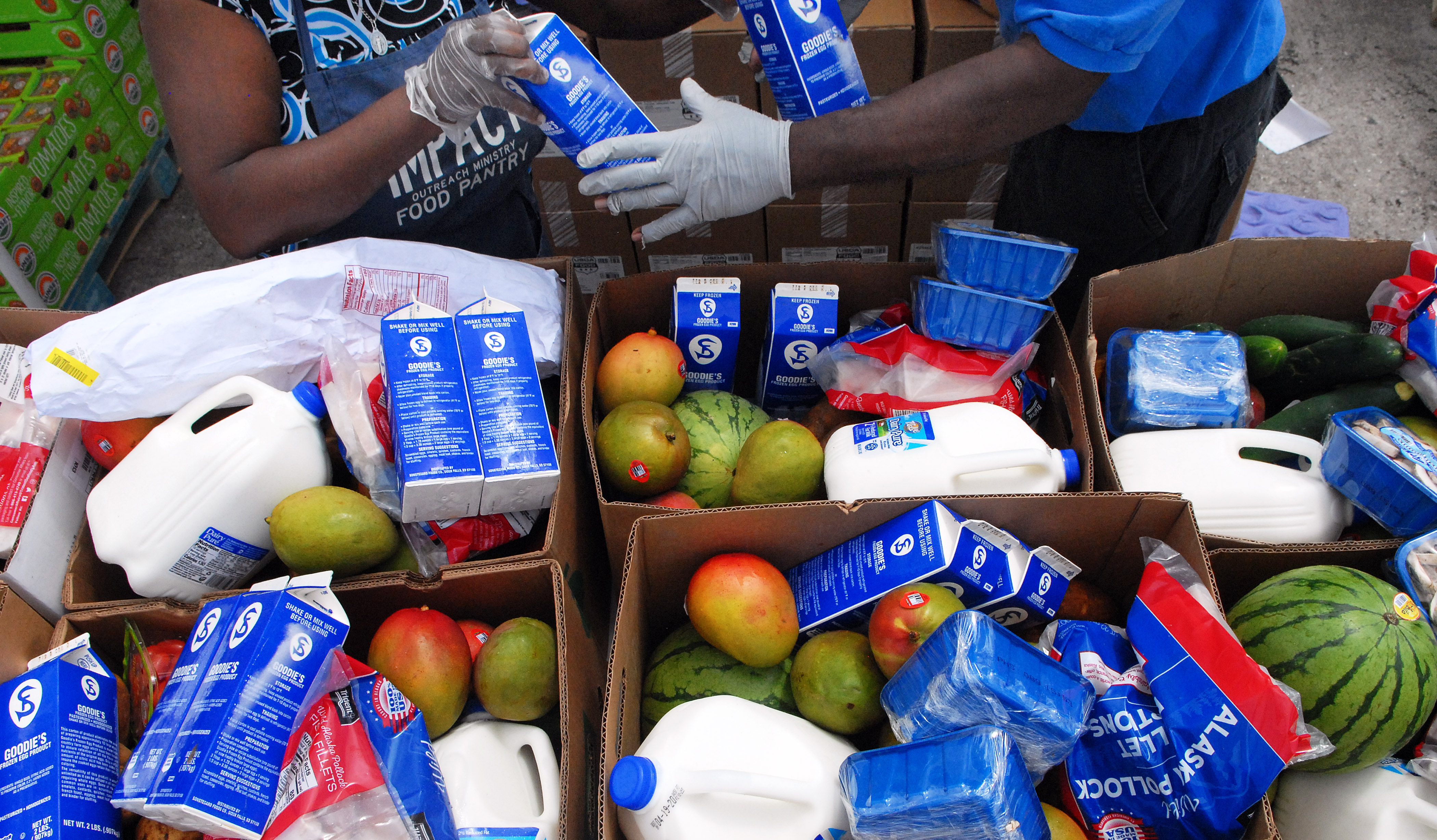 Workers fill boxes of food from the Second Harvest Food Bank of Central Florida to be distributed to needy families on April 6, 2020 in Orlando, Florida.