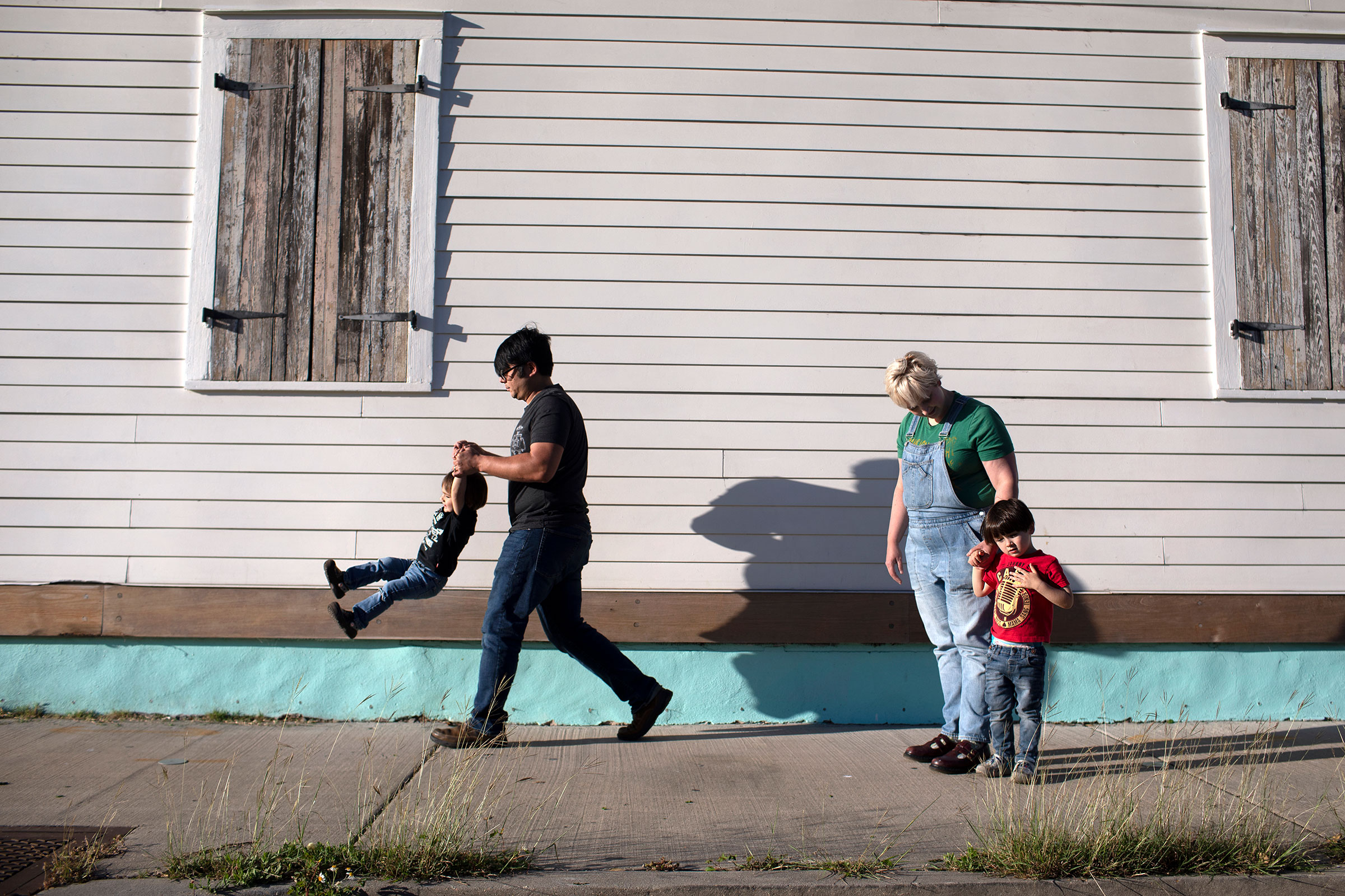 Mickey Harrison and his wife Laurie Halbrook take their kids eighteen month old Jack, left, and Michael, 3, on a walk through their neighborhood in New Orleans. (Kathleen Flynn for TIME)
