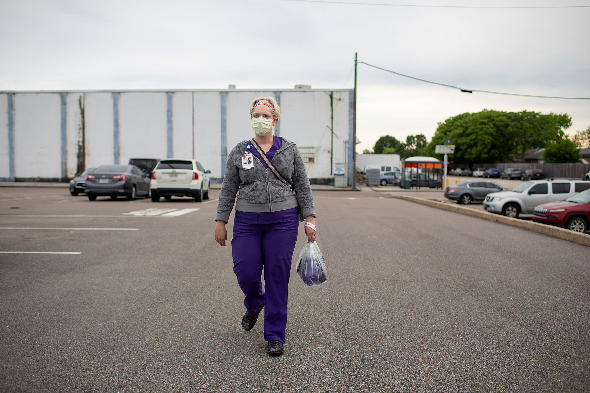Laurie Halbrook walks to her car after a finishing a shift at Ochsner Medical Center in Jefferson Parish on April 2, 2020. (Kathleen Flynn for TIME)