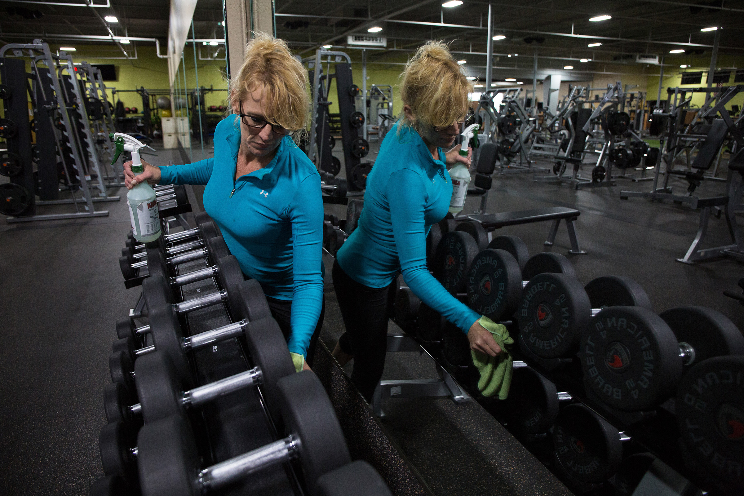 A Gold's Gym worker cleans before reopening, Evans, Ga., April 23, 2020. (OK McCausland/The New York Times)