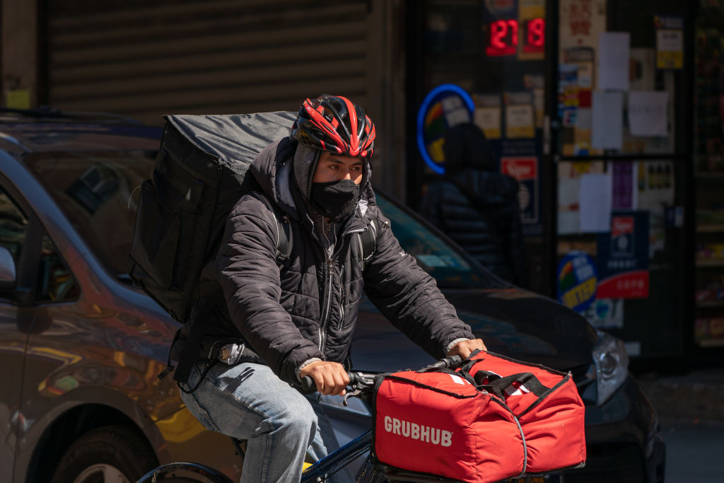 A food delivery courier for Grubhub wears a protective mask in New York, U.S., on Monday, April 6, 2020. (Jeenah Moon–Bloomberg/Getty Images)
