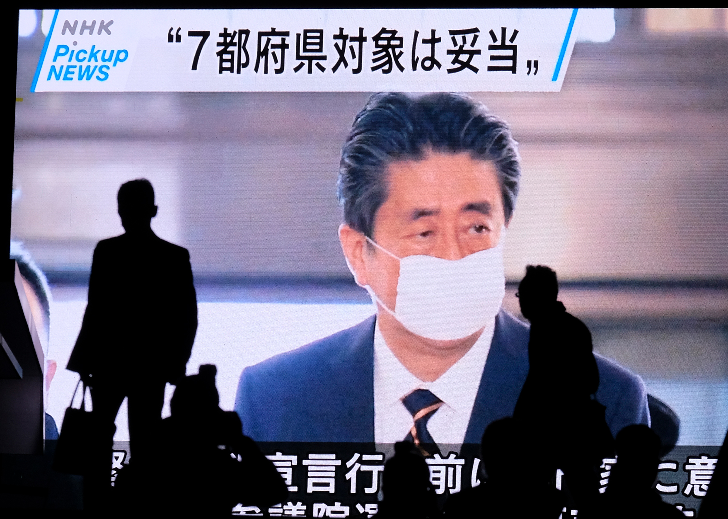 A screen displays news footage of Japan's Prime Minister Shinzo Abe at parliament in Tokyo on April 7 (Kazuhiro Nogi—AFP/Getty Images)