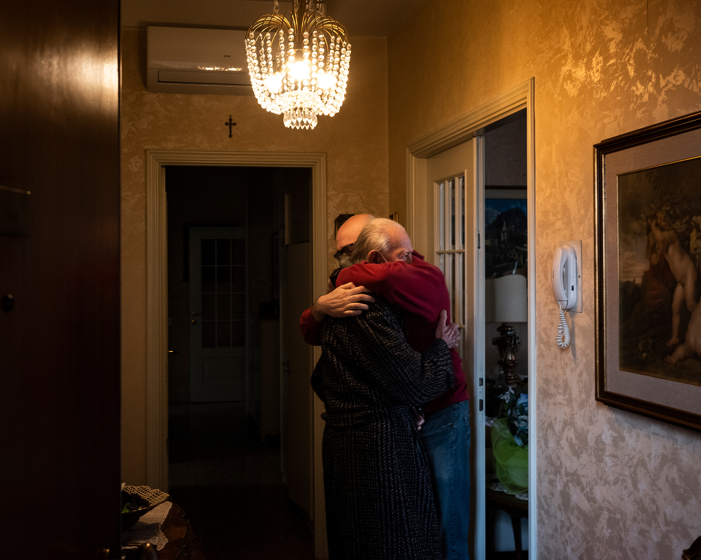 A son hugs his father before the older man, a suspected case of COVID-19, is hospitalized in Piacenza. (Lorenzo Meloni—Magnum Photos for TIME)