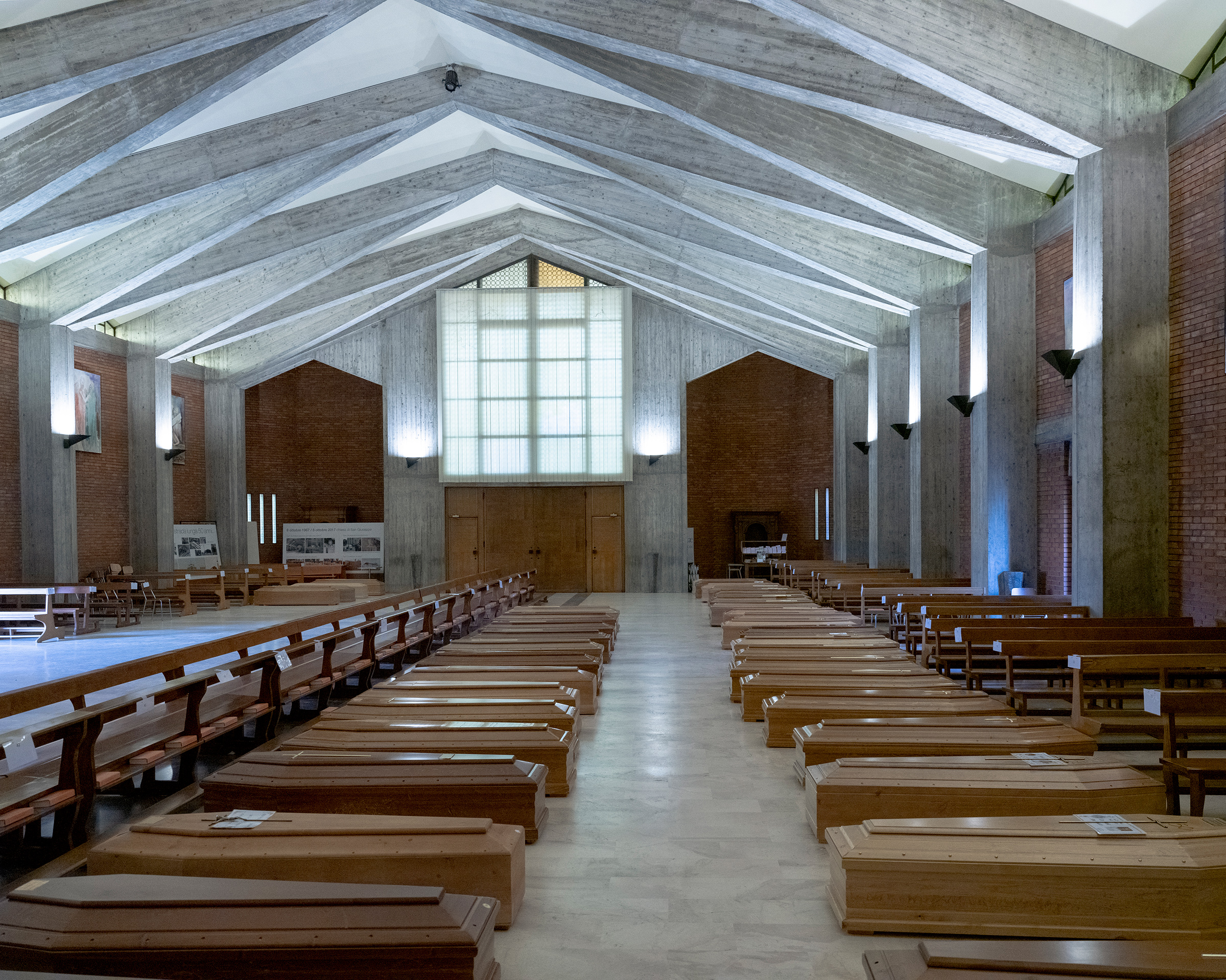 Dozens of coffins are housed inside an otherwise empty church in Seriate, near Bergamo.