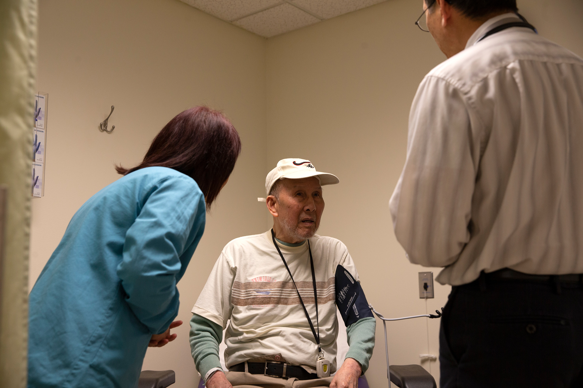 Bing Hong Liu (C) talks to to Dr. Alan Chun (R) through an interpreter at the International Community Health Services medical clinic in their assisted living facility, the Legacy House, on March 20 in Seattle. (Karen Ducey—Getty Images)