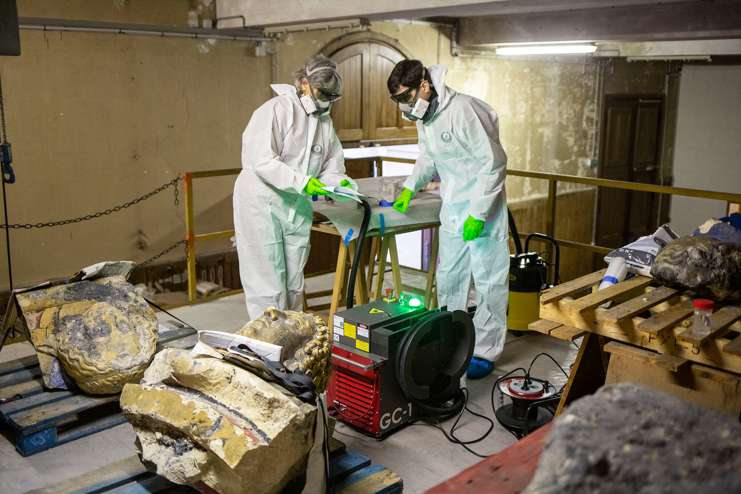 Véronique Vergès-Belnin and Jérémy Henin, surrounded by various busts and stones from the cathedral, at work in the national monuments research laboratory in October.