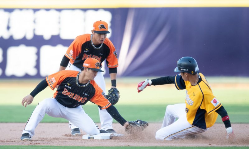 Infielder Wei Chen Wang (R) #9 of CTBC Brothers is tagged out during the CPBL game between CTBC Brothers and Uni-President Lions at Taichung Intercontinental Baseball Stadium on April 12, 2020 in Taichung, Taiwan. Taiwan's Chinese Professional Baseball League started April 11 2020. Due to COVID-19, only staff and members of the media were allowed to attend.