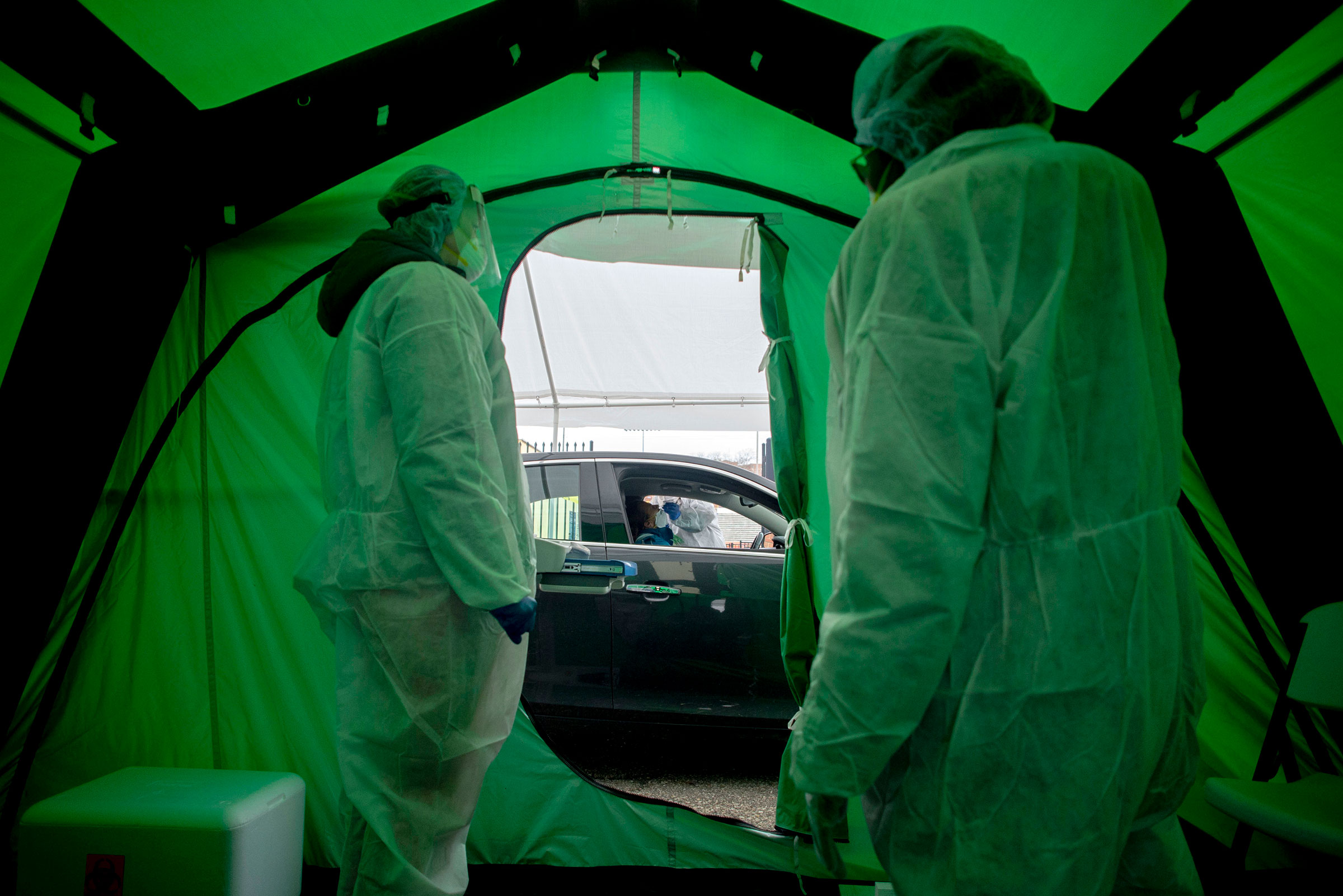 Medical workers watch as one of the first 50 people are tested for coronavirus at Flint, Michigan's first drive-thru testing site on April 15, 2020. (Jake May—The Flint Journal/AP)