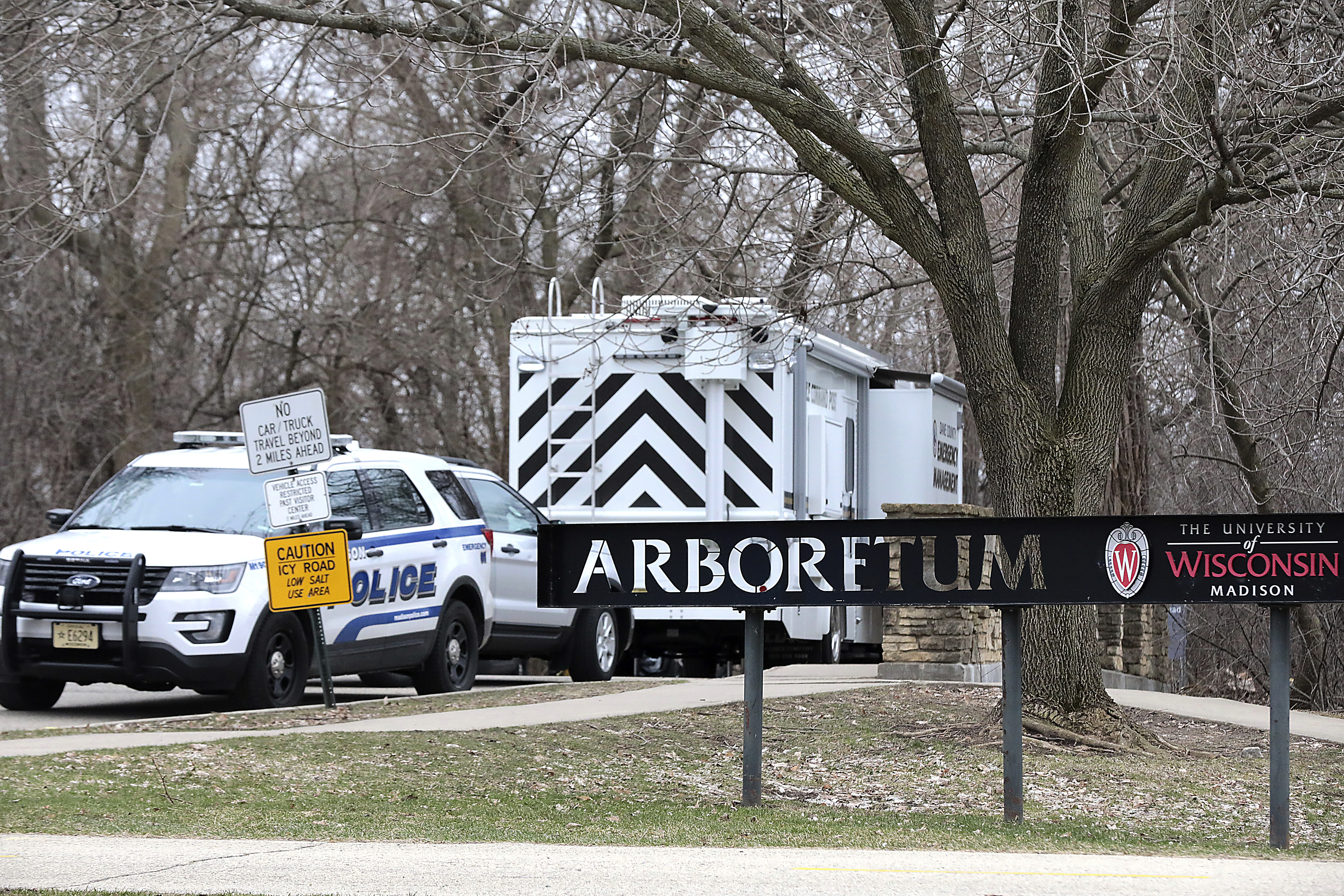 Police vehicles stationed outside the UW-Arboretum in Madison, Wis. as law enforcement personnel investigate a double homicide on March 31, 2020.