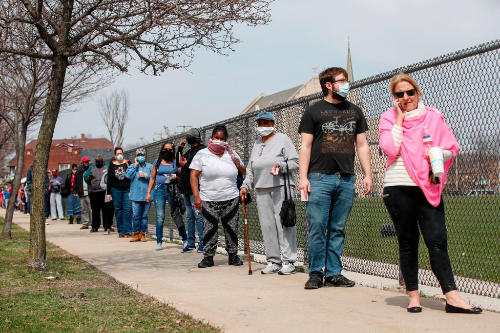 Residents wait in line to vote in a presidential primary election outside the Riverside High School in Milwaukee, Wisconsin on April 7, 2020. (Kamil Krzaczynski—AFP/Getty Images)