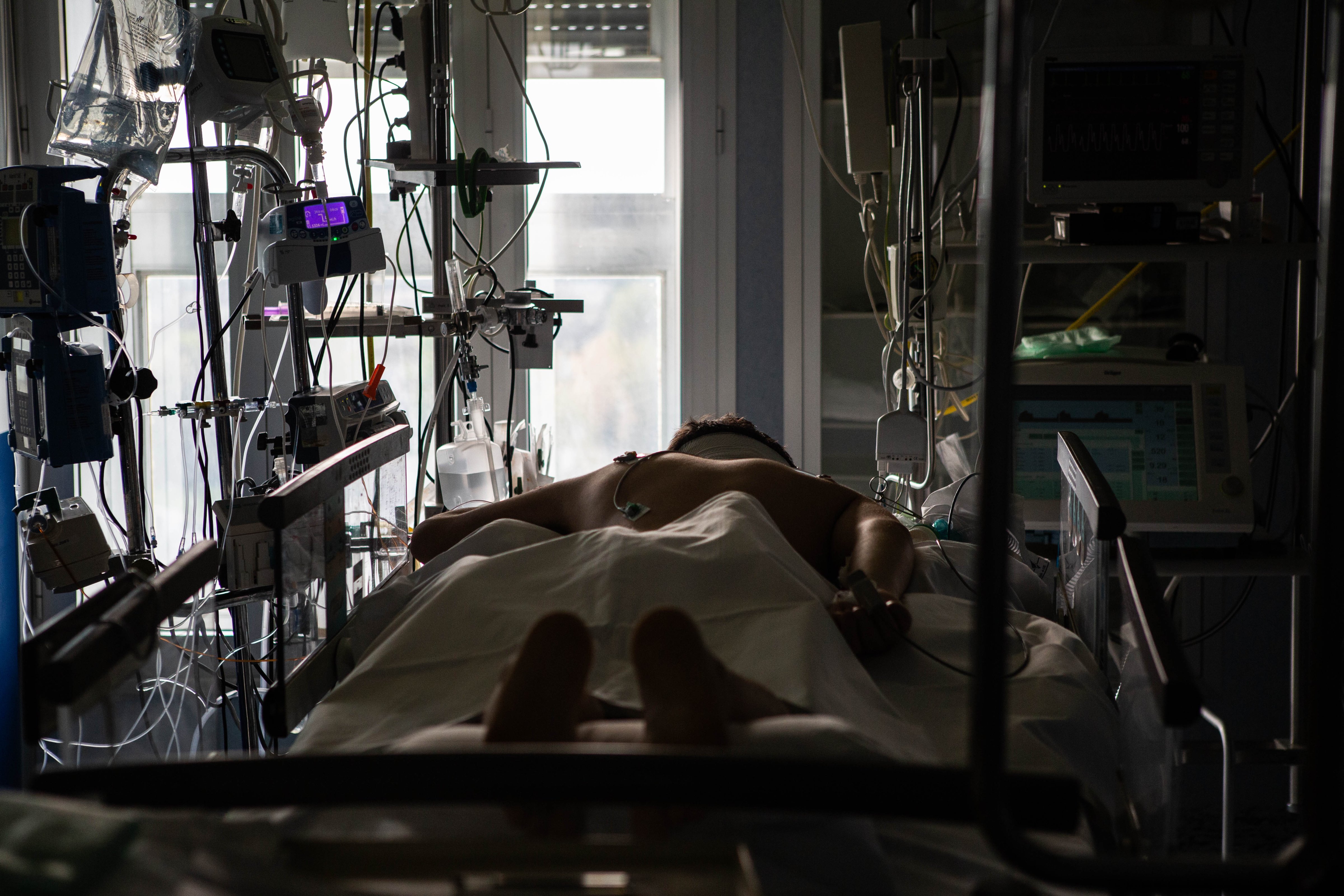 A patient lies in the intensive care unit at the Cremona Hospital in Northern Italy. (Arianna Pagani)