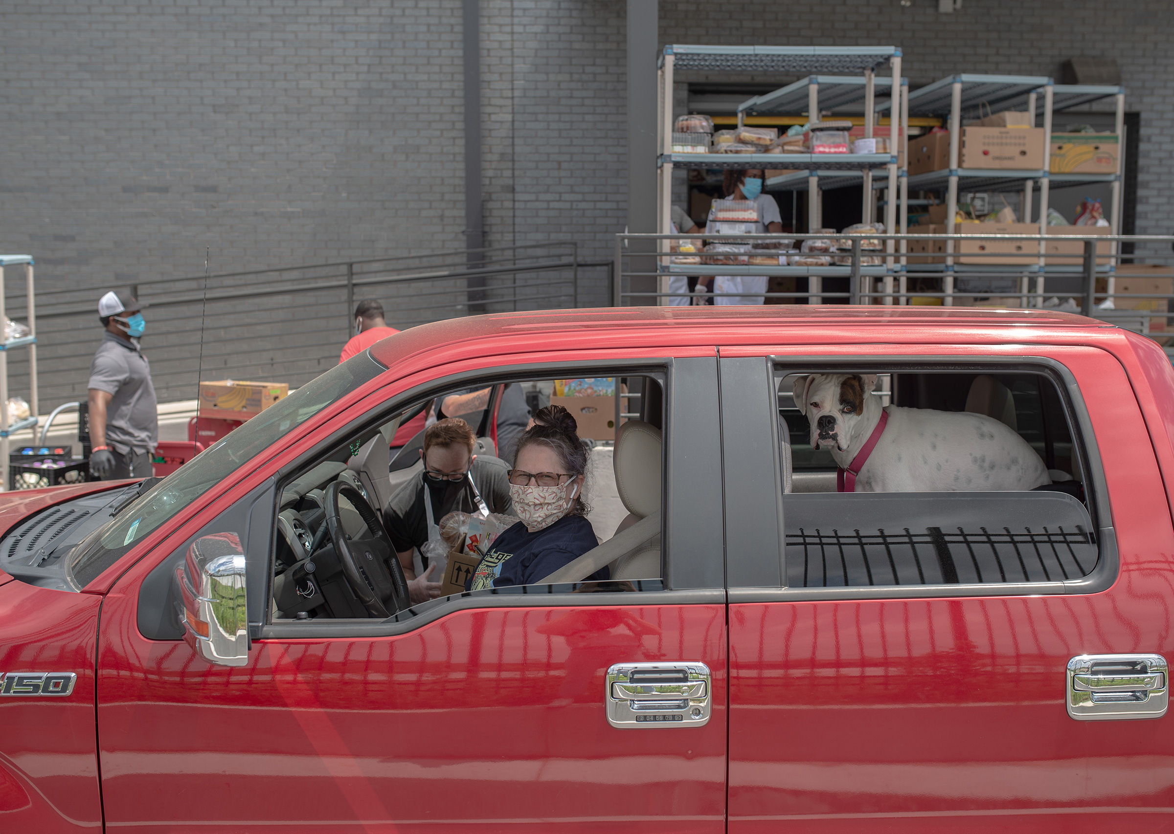 Stacy Aaensom, of Tulsa, Okla., on May 4. She picked up groceries at the Iron Gate drive-through food pantry for some relatives. “They haven’t asked me to do that but they don’t have a car,” she says, "so I’ve been doing that to help them out." (September Dawn Bottoms for TIME)