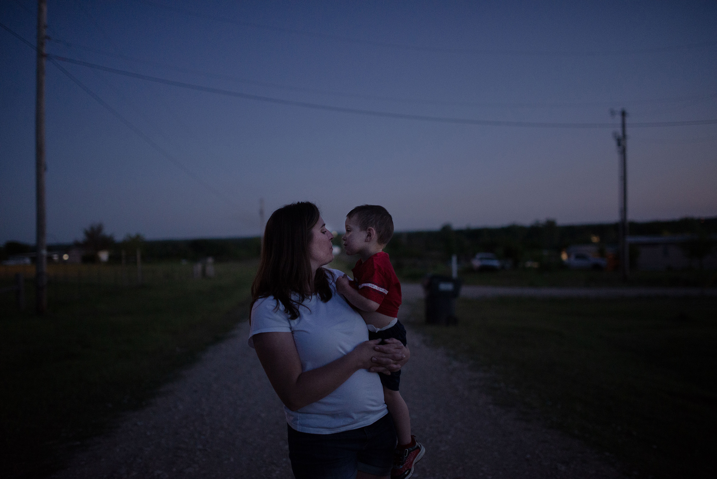 <strong>Christina Thomason 39, and son Logan, Tecumseh, Okla.</strong> “You can’t tell people to stay home and not care for them. I’m watching everything we worked for being flushed down the toilet. How are we going to come back from this?” she says. (September Dawn Bottoms for TIME)