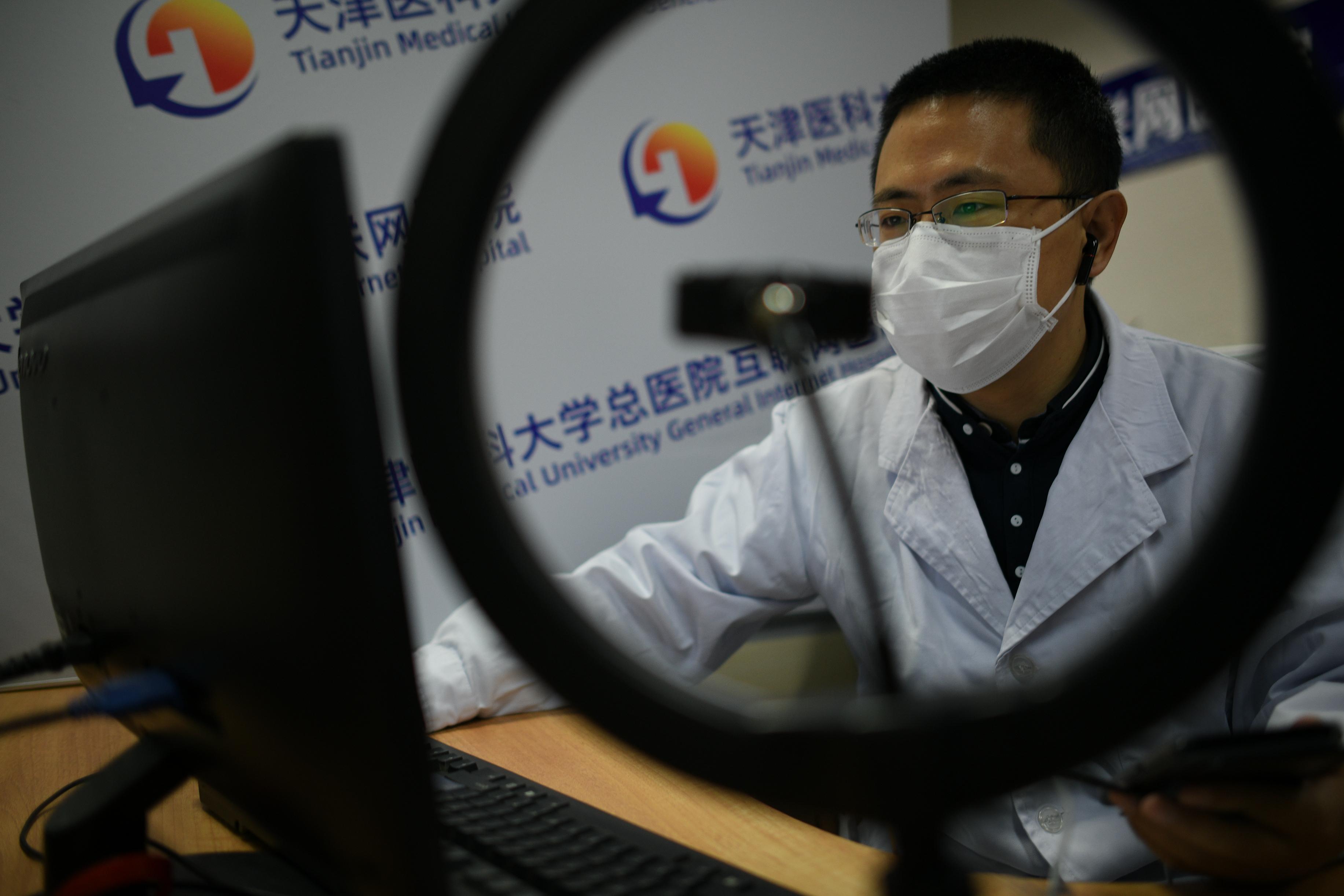 A respiratory and critical care medicine department doctor communicates with patients via Tianjin Medical University General Internet Hospital's platform on March 4, 2020 in Tianjin, China. (Tong Yu/China News Service via Getty Images)