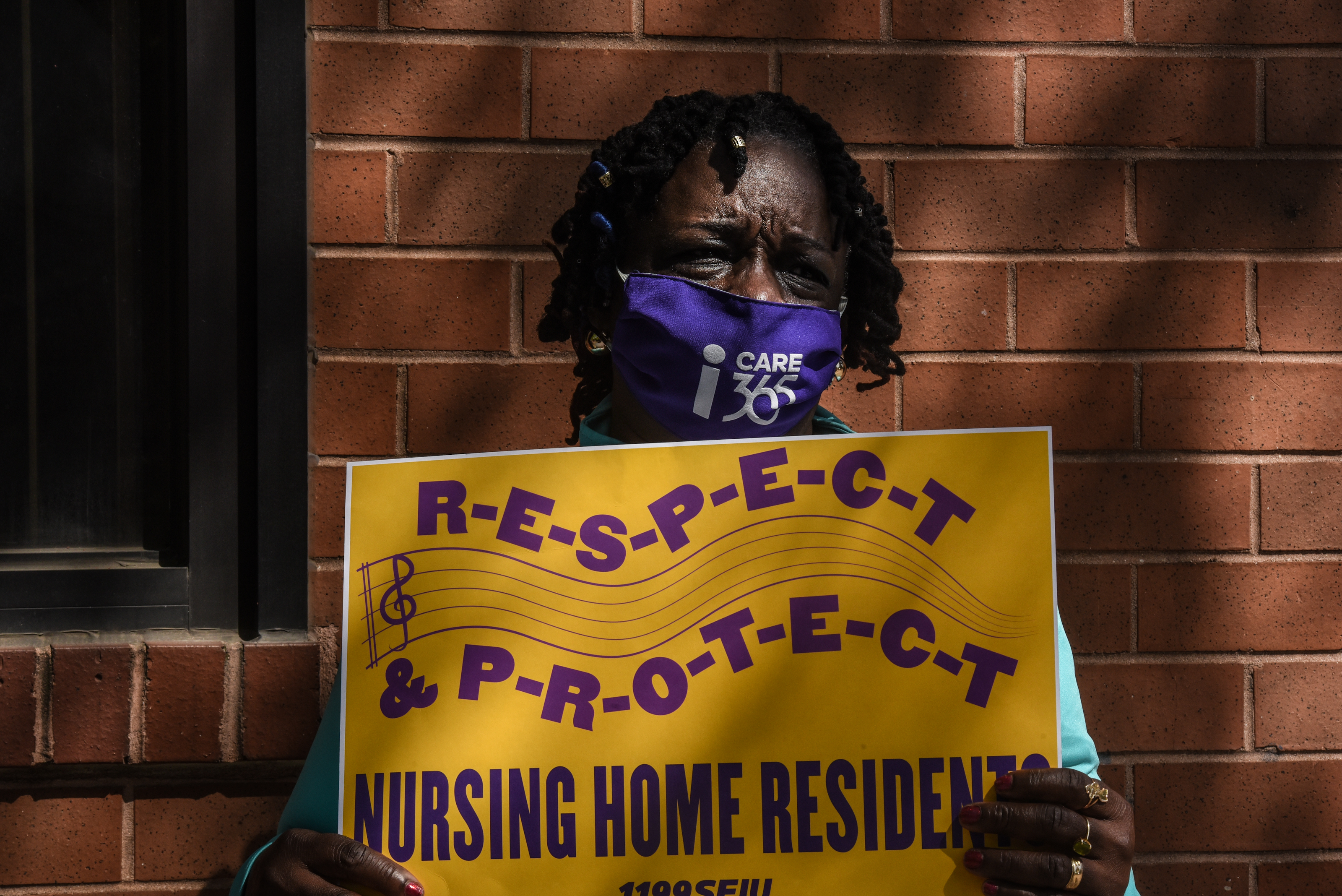 A nursing home worker participates in a vigil outside of a nursing home in Brooklyn, N.Y. on May 21, 2020. Workers say they need safer conditions to better protect nursing home residents and the people who care for them from the coronavirus. (Stephanie Keith—Getty Images)