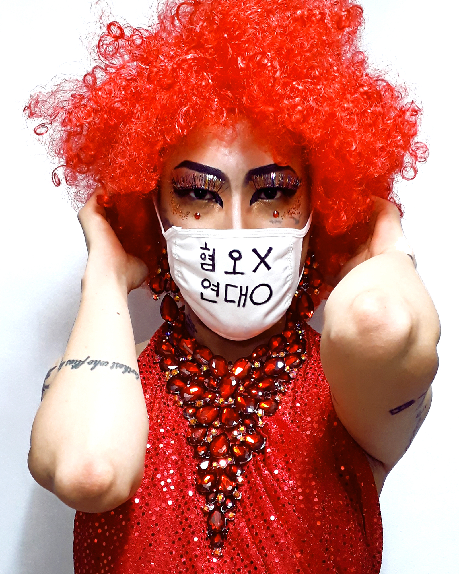 Artist and drag performer Heezy Yang poses in a photo he posted to social media following the Itaewon coronavirus outbreak. The message on his mask translates roughly: 