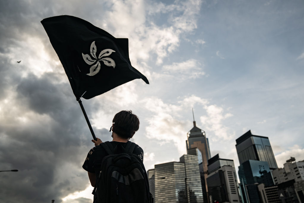 A Hong Kong protester waves a black flag on a street outside the Legislative Council ahead of the 22nd anniversary of the city's handover to China on July 1, 2019. (Anthony Kwan&mdash;Getty Images)