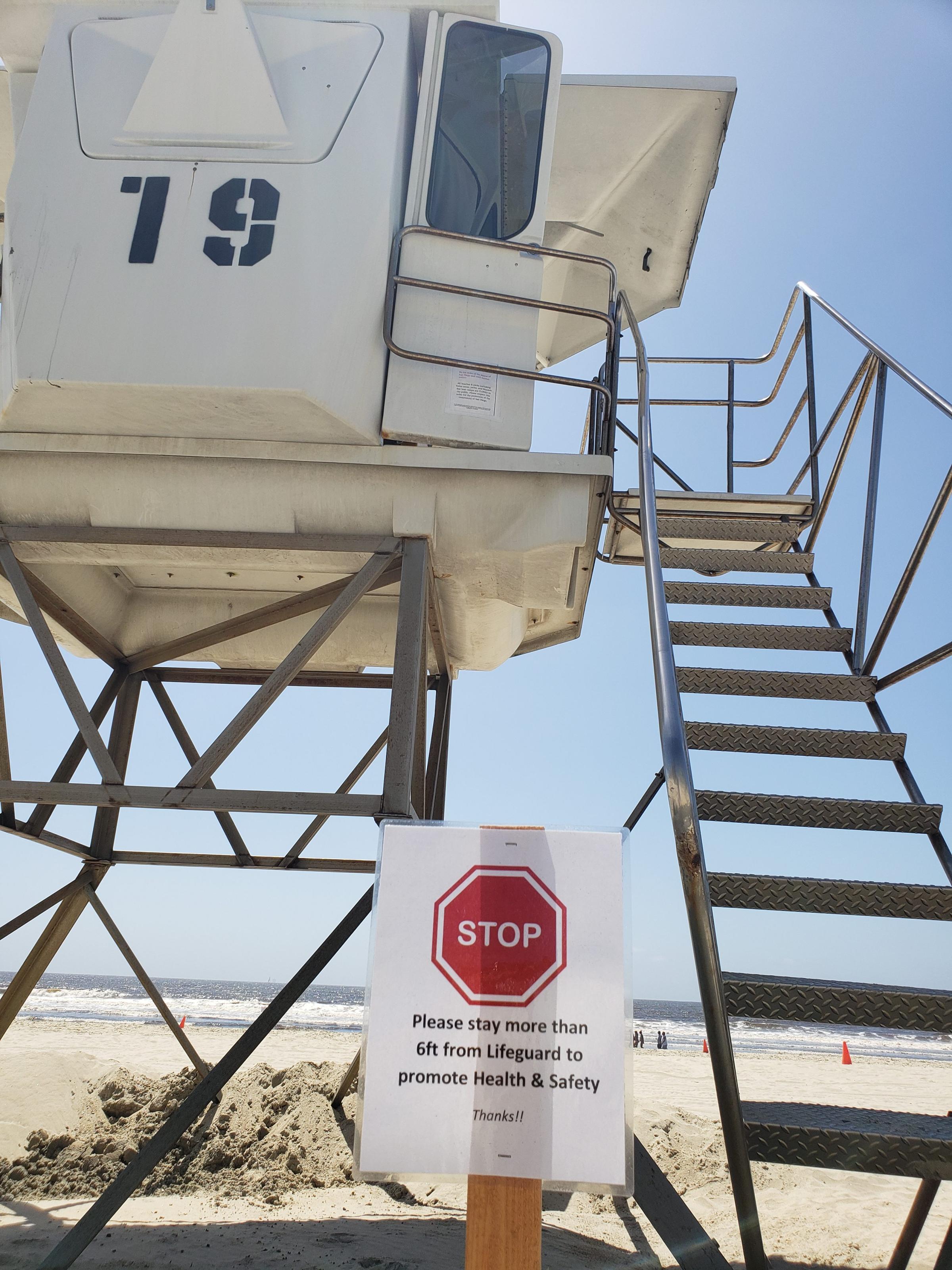A sign outside a lifeguard tower on a beach in San Diego, Calif.