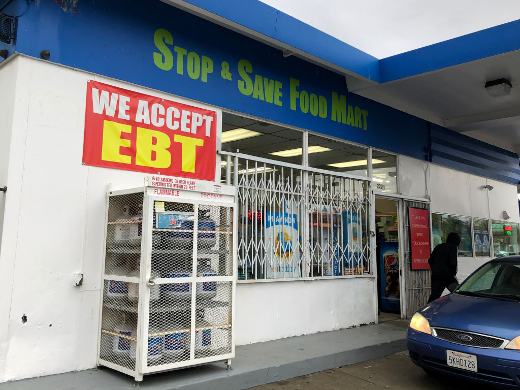 A sign noting the acceptance of electronic benefit transfer (EBT) cards that are used by state welfare departments to issue benefits is displayed at a convenience store on Dec. 4, 2019 in Richmond, Calif. (Justin Sullivan—Getty Images)