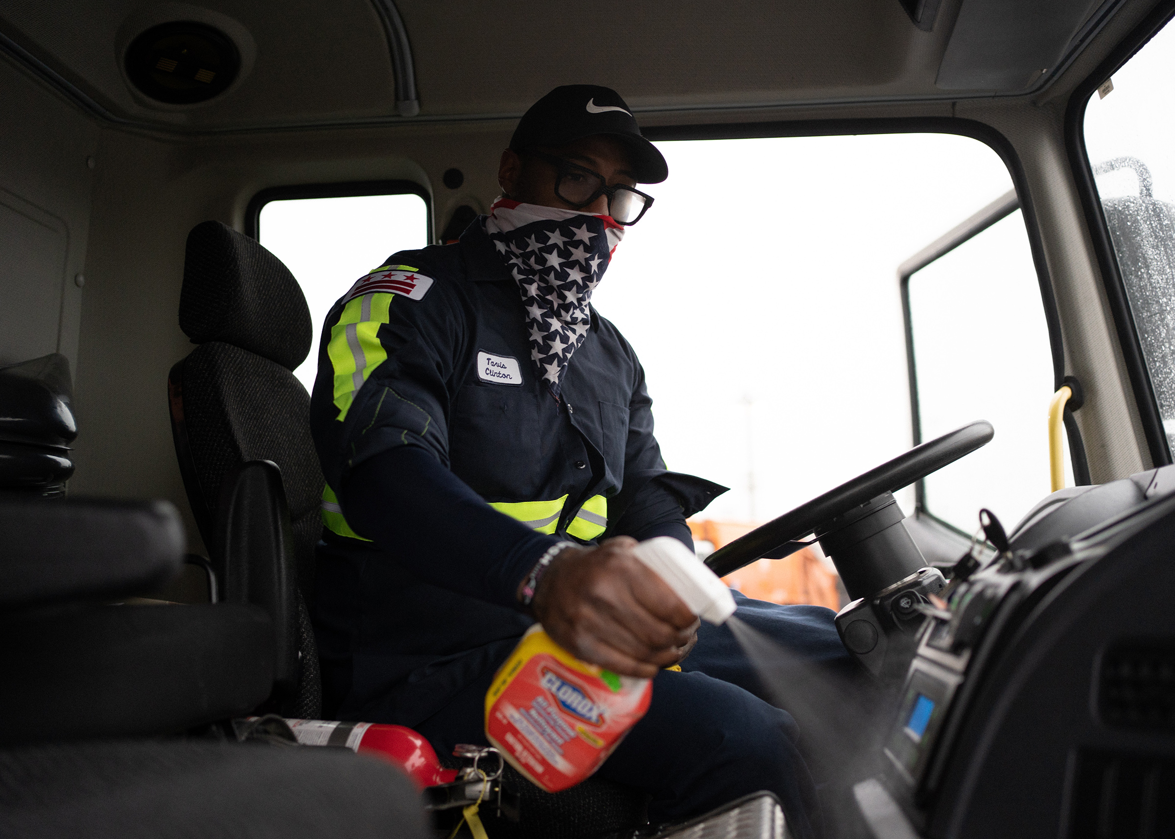 Sanitation Crew Chief, Tavis Clinton, 41, disinfects his truck before beginning his route.
