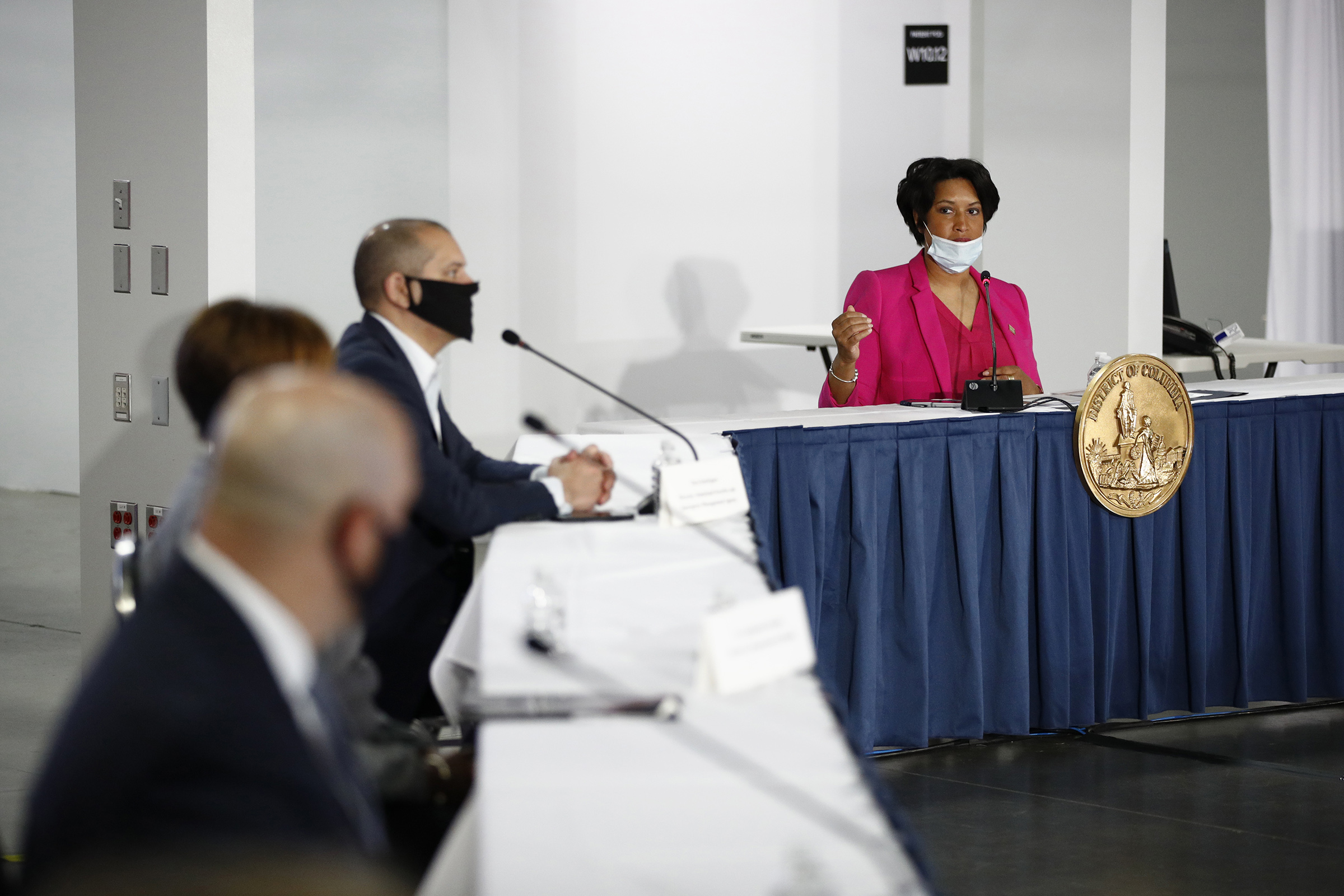 D.C. Mayor Muriel Bowser, right, speaks during a news conference about the coronavirus inside the Walter E. Washington Convention Center on May 11. (Patrick Semansky—AP)