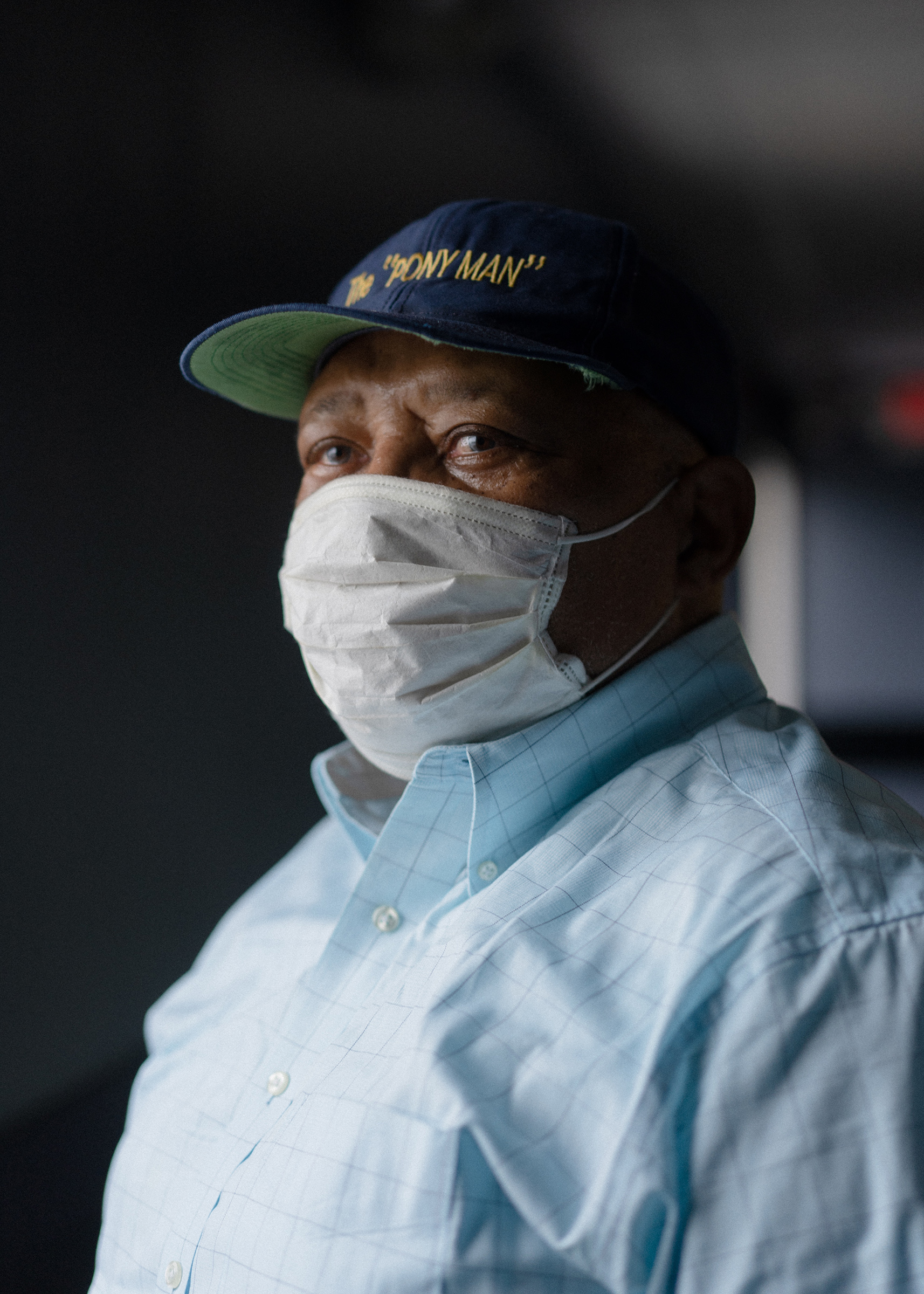 Retired Sanitation Worker, Mr. Maurice "Pony Man" Queen, 72, stands in the hallway of the Larry Hutchins Building at the DC Department of Public Works Solid Waste Collections Division in Northeast Washington, DC.