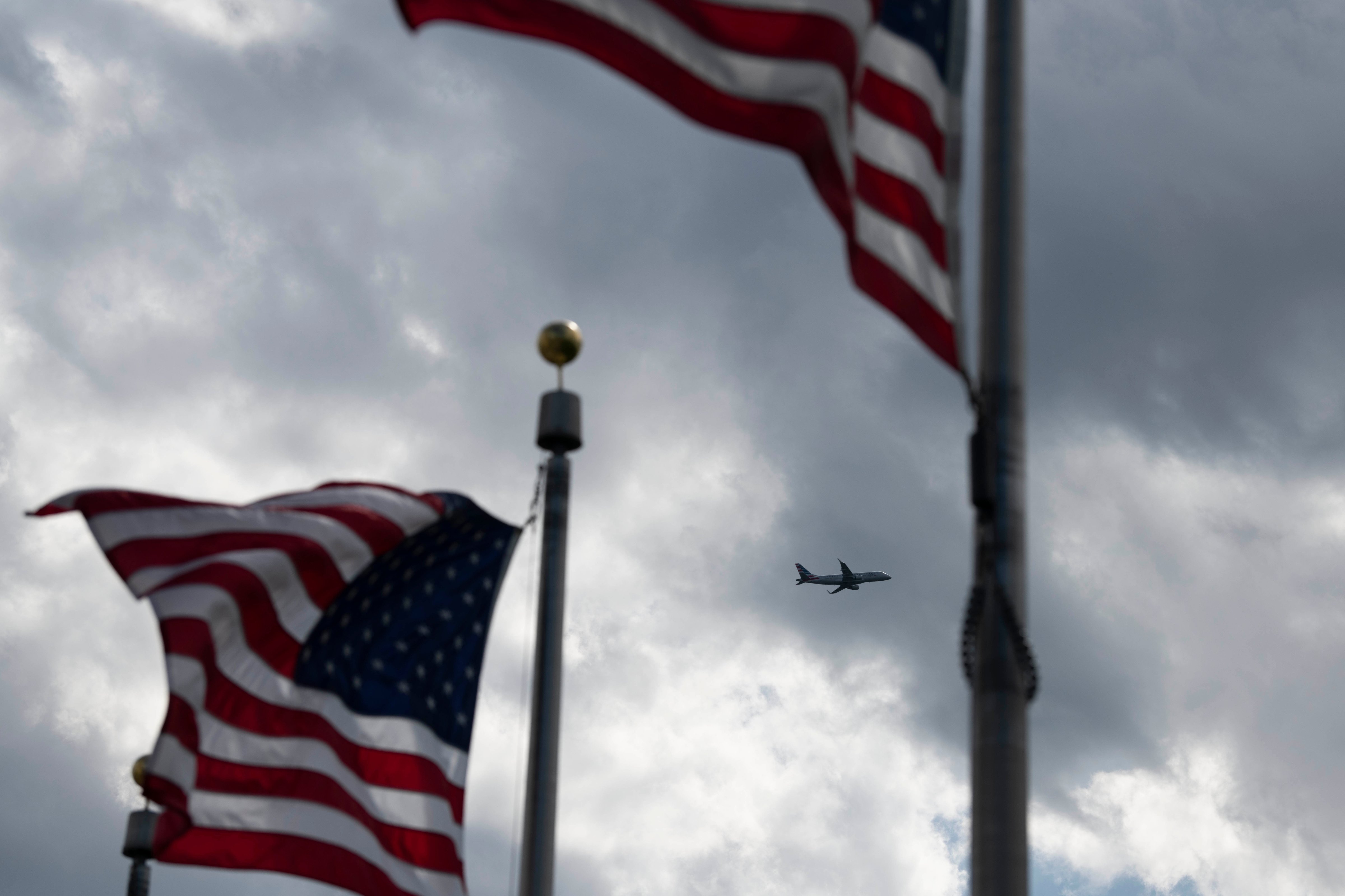A plane flies in the sky over Washington D.C on April 21, 2020. (Liu Jie—Xinhua News Agency/Getty Images)