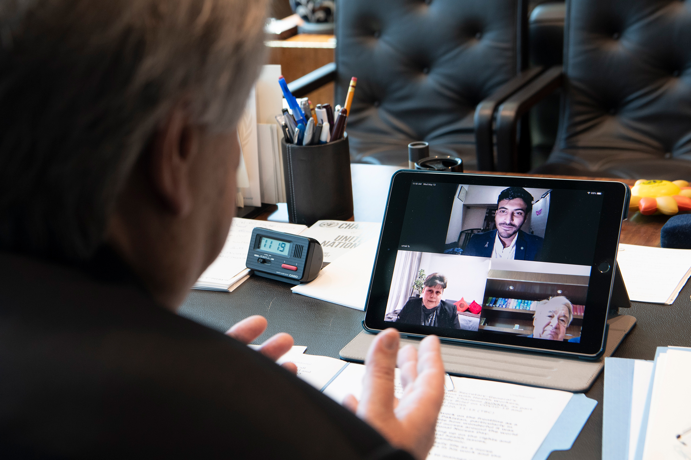 Guterres in a three-way video call with frontline mental health workers, Mr. Umair Bachlani in Pakistan and Ms. Charlene Sunkel in South Africa. (Eskinder Debebe—UN Photo.)