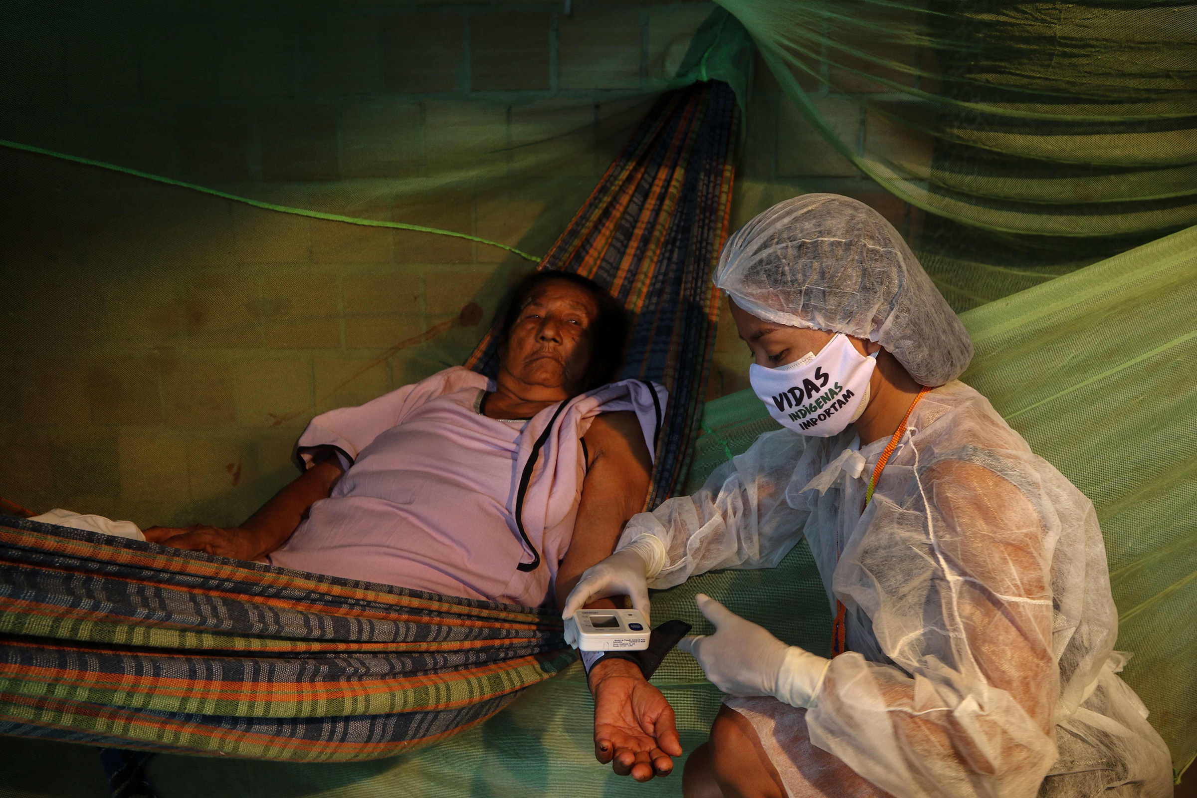 Nurse technician Vanda Ortega Witoto, 32, takes care of a patient in Parque das Tribos, an indigenous community near Manaus, the capital of Brazil’s northern Amazonas state