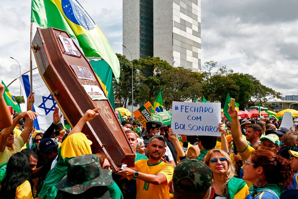 Supporters of Brazilian President Jair Bolsonaro demonstrate with a coffin with the portrait of Brazilian former Justice Minister Sergio Moro, Brazilian and Israeli flags during a rally in Brasilia on May 17, 2020, amid the novel coronavirus pandemic. (SERGIO LIMA/AFP via Getty Images)
