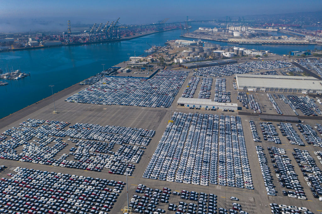 An aerial view shows cars that were offloaded from ships at Wallenius Wilhelmsen Logistics (WWL) as the spread of the coronavirus pandemic cripples the economy on April 26, 2020 in Wilmington, California. The sudden high unemployment crisis is hitting car sales as travel restrictions and widespread social distancing measures continue across most of the nation to fight the coronavirus pandemic. (David McNew–Getty Images)