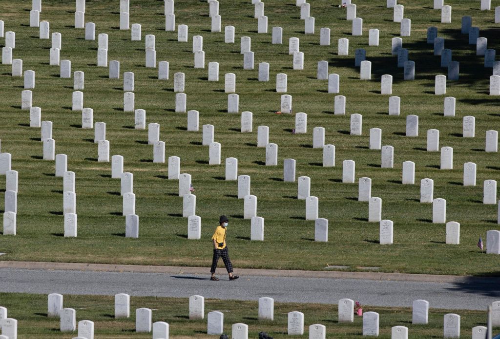 A man walks amongst the graves on Memorial Day at the Golden Gate National Cemetery in San Bruno, Calif., amid the coronavirus outbreak on May 25, 2020. (Liu Guanguan/China News Service—Getty Images)