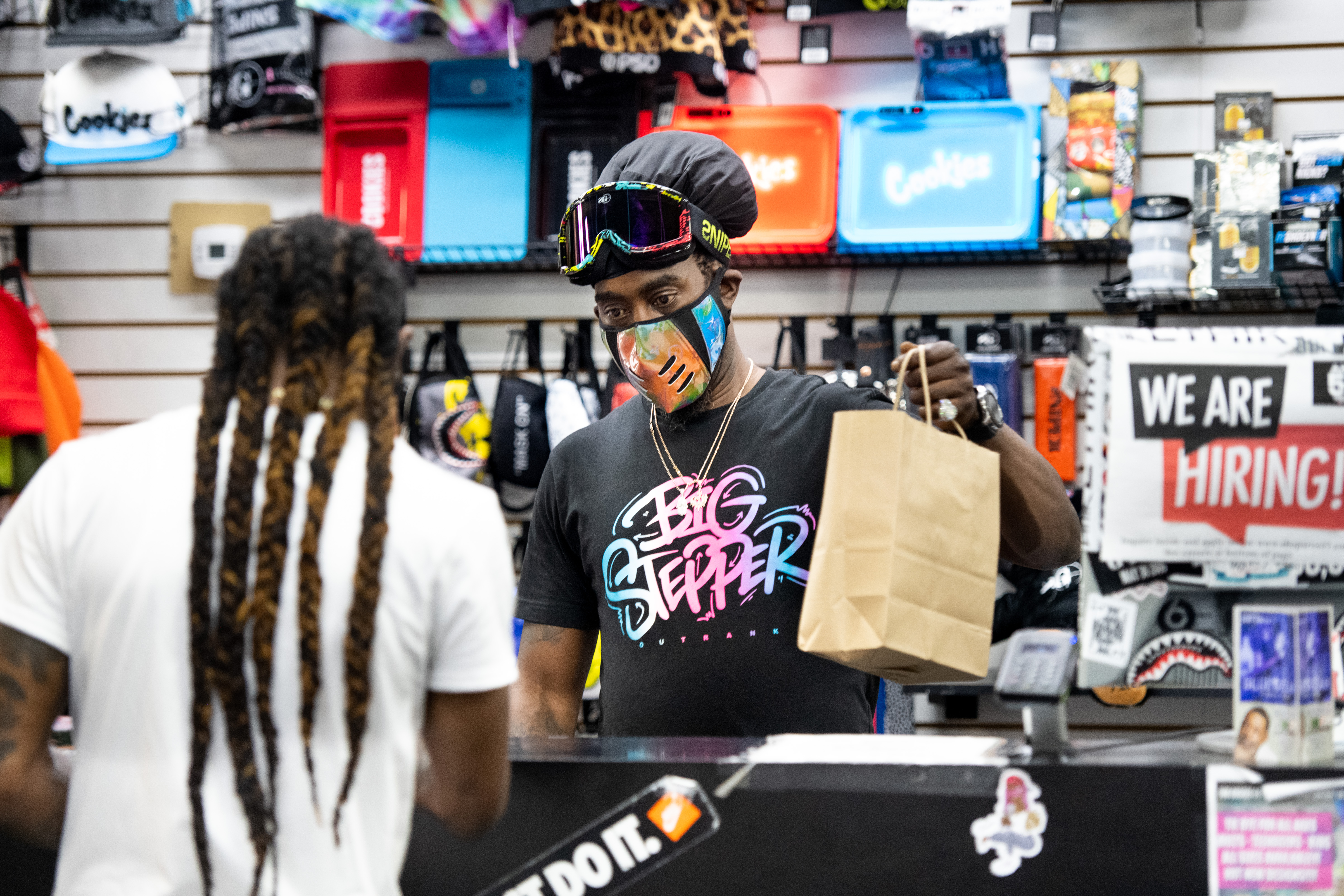 Small business owner Birl Hicks helps a customer at Columbia Place Mall in Columbia, South Carolina on April 24, 2020.