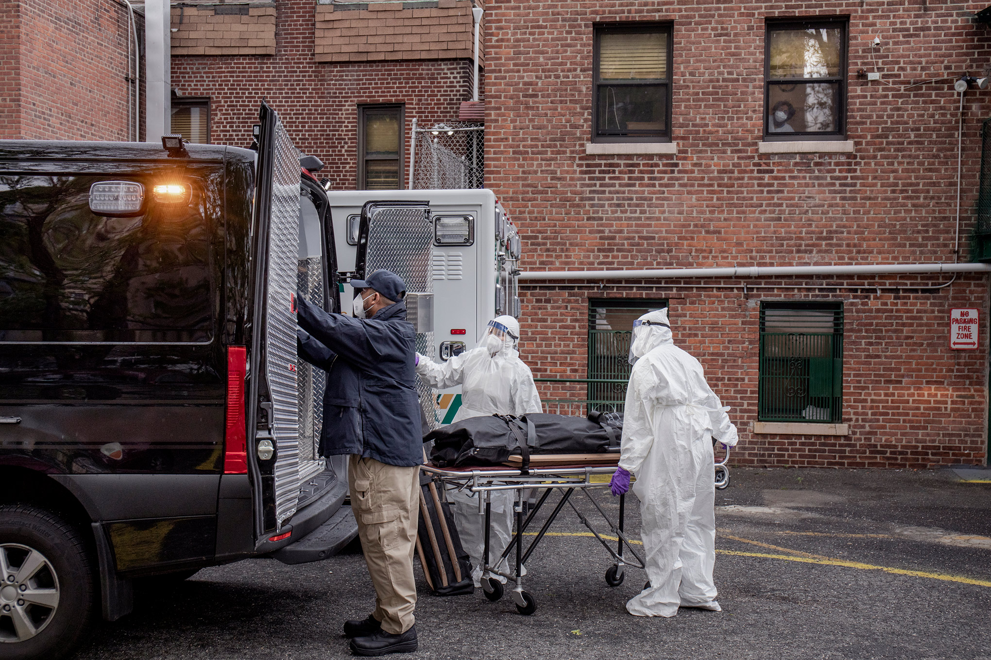A collection team removes remains from a residence in the Bronx on May 8. Twelve hour shifts have become routine. (Natalie Keyssar for TIME)