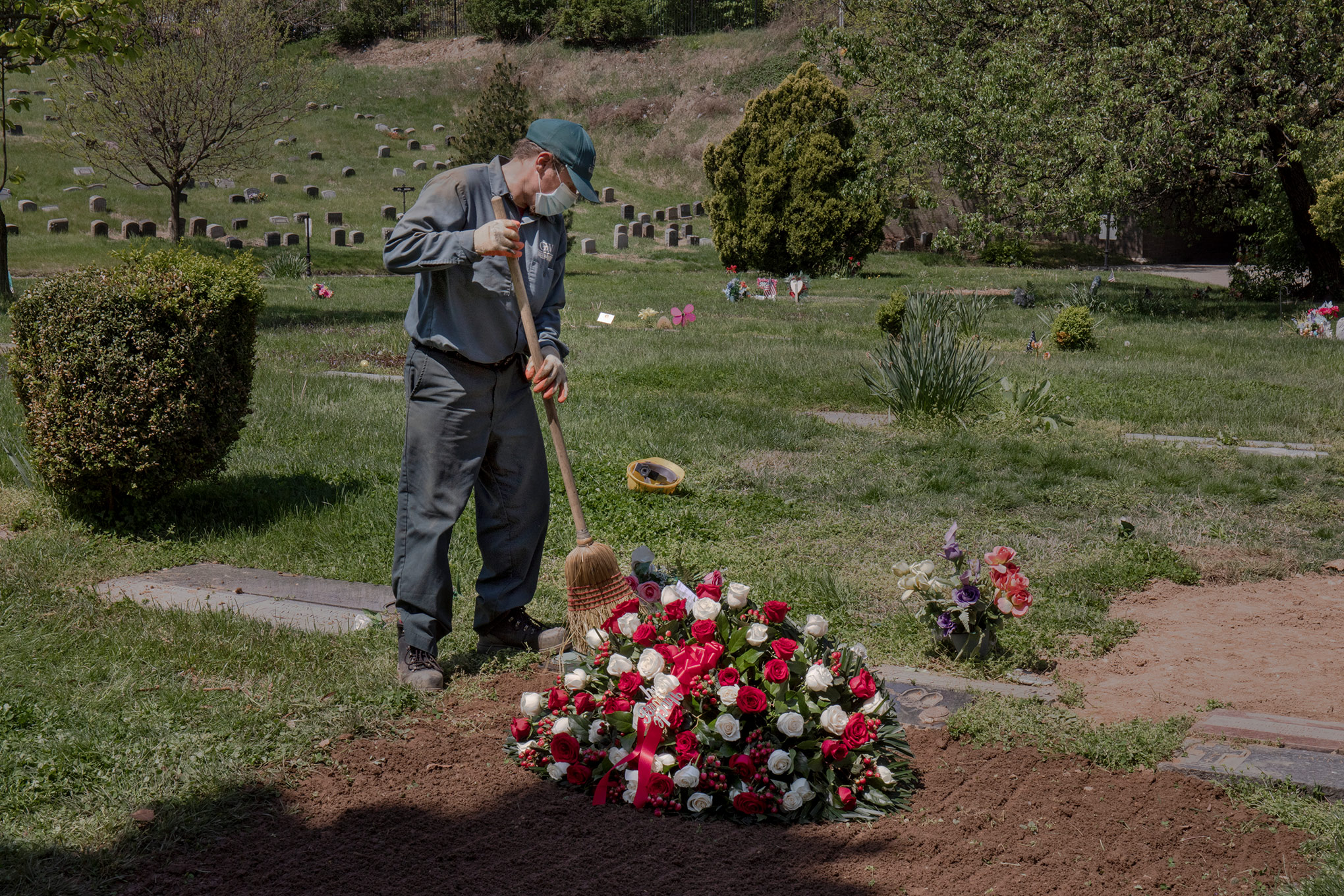 Social distancing regulations have made funerals lonely and rare. On May 4, Janusz Karkos tends the grave of a COVID-19 victim at Brooklyn's Green-Wood Cemetery. (Natalie Keyssar for TIME)