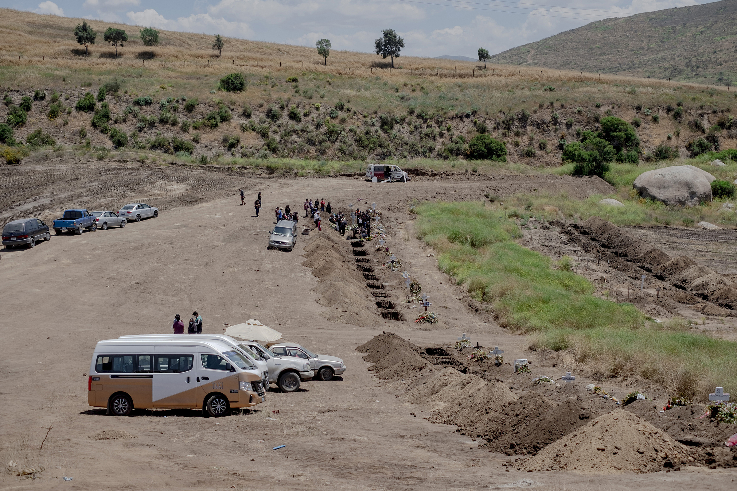 A burial at a newly dug grave at the Municipal Cemetery No. 13 in Tijuana, Mexico, on May 12. Experts say Mexico's COVID-19 case count and death toll have been underreported. (Fred Ramos—Bloomberg/Getty Images)