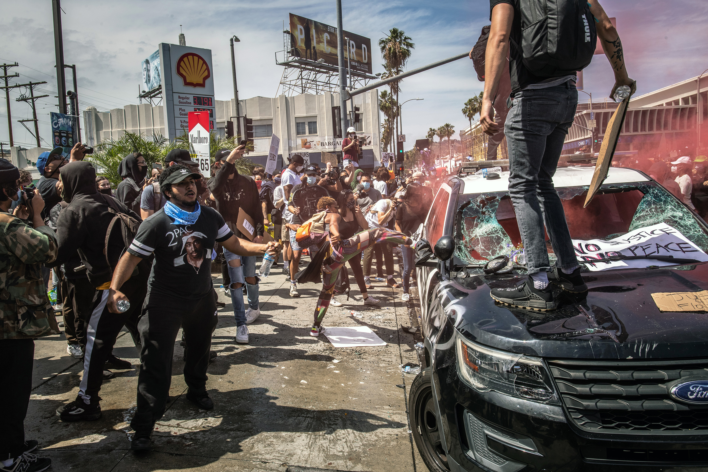 A police vehicle is vandalized by protesters in Los Angeles on May 30. Demonstrators returned to the nation's streets in sweeping fashion on Saturday in a show of national anger and sorrow over the death of George Floyd.