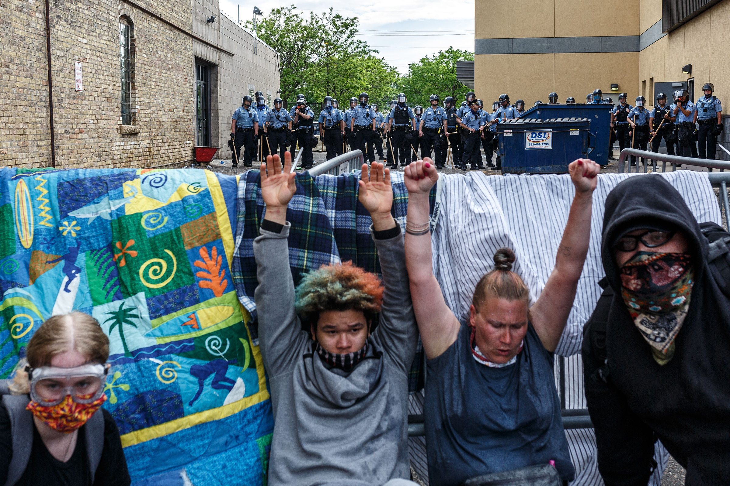 Protesters hold their hands up as they cry from from tear gas during a demonstration calling for justice for George Floyd on May 27, two days after his death. (Kerem Yücel—AFP/Getty Images)