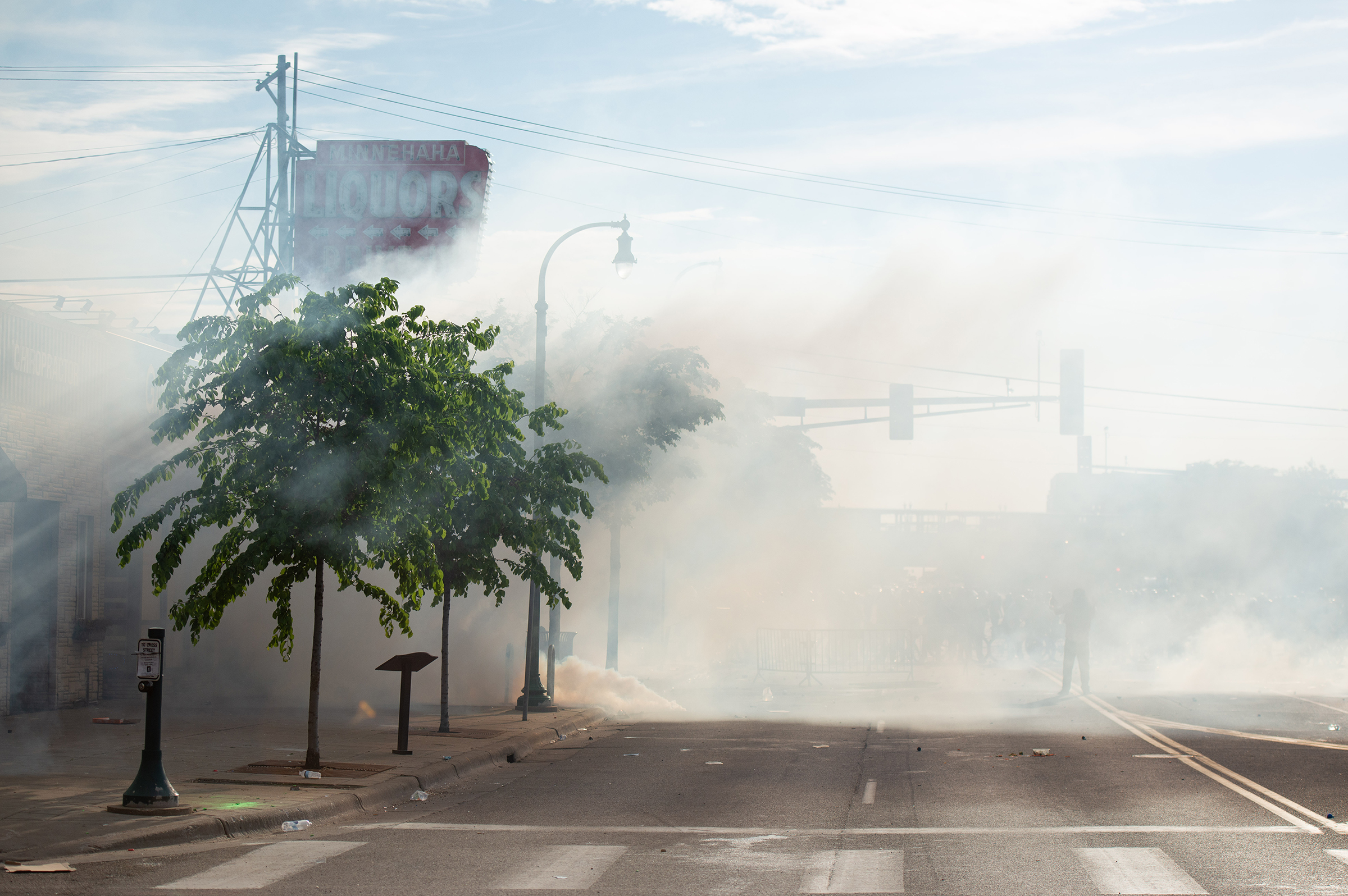 Clouds of tear gas linger in the air over Lake Street during the second day of protests in Minneapolis on May 27. (Steel Brooks—Anadolu Agency/Getty Images)