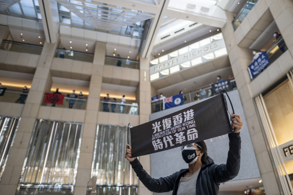 A demonstrator holds a banner reading "Liberate Hong Kong, Revolution of our Time" during a protest in Hong Kong on April 29, 2020. (Justin Chin—Bloomberg/Getty Images)