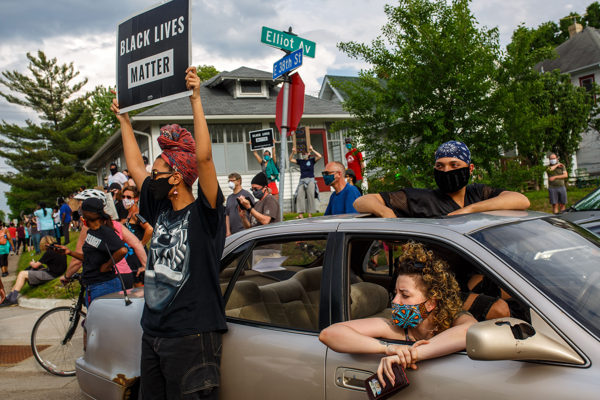 People hold signs and protest after a Minneapolis Police Department officer allegedly killed George Floyd, on May 26 in Minneapolis (Kerem Yucel—AFP/Getty Images)