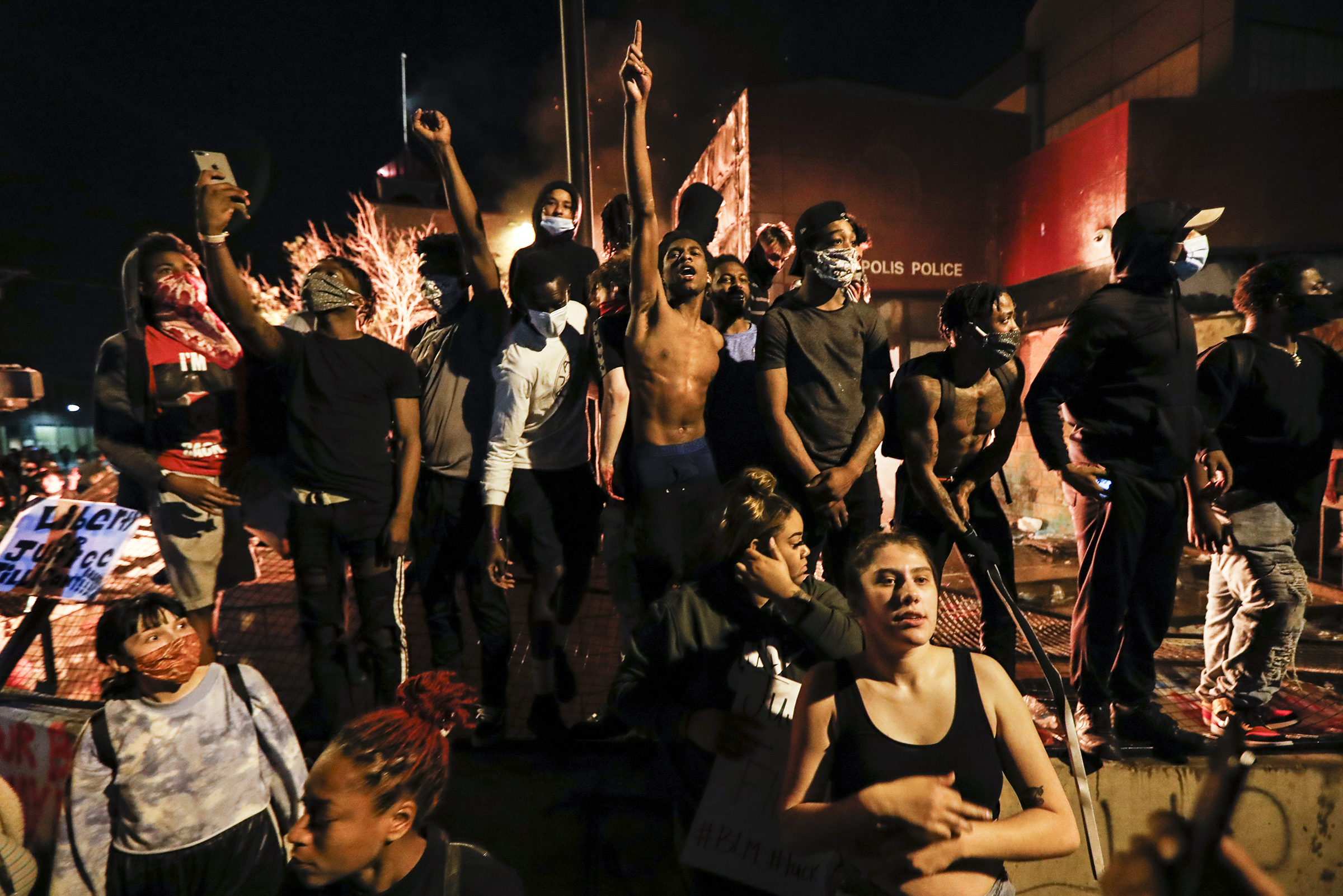 Protesters demonstrate outside of the burning precinct on May 28. (John Minchillo—AP)