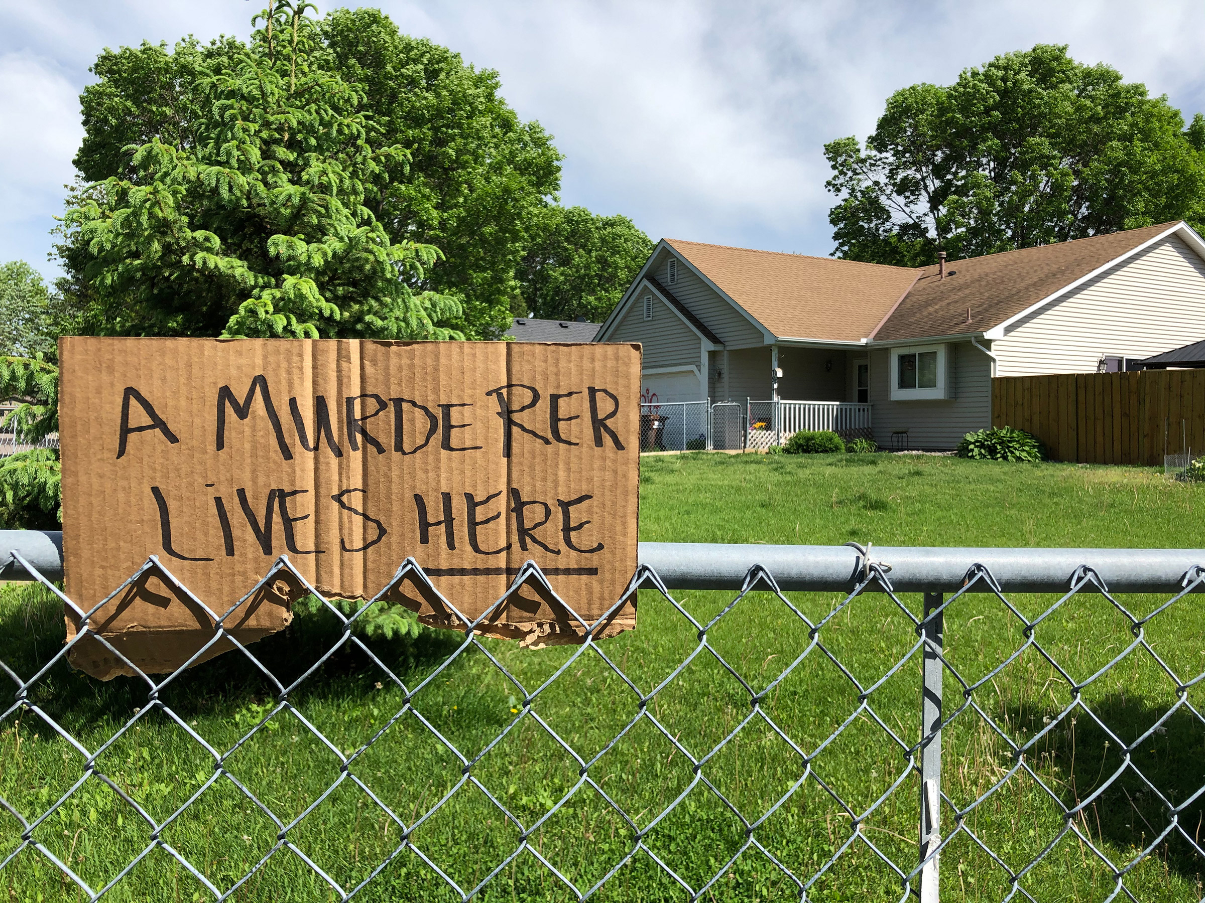A sign outside of police officer Derek Chauvin's house in Oakdale, Minn., on May 28. (Patience Zalanga for TIME)