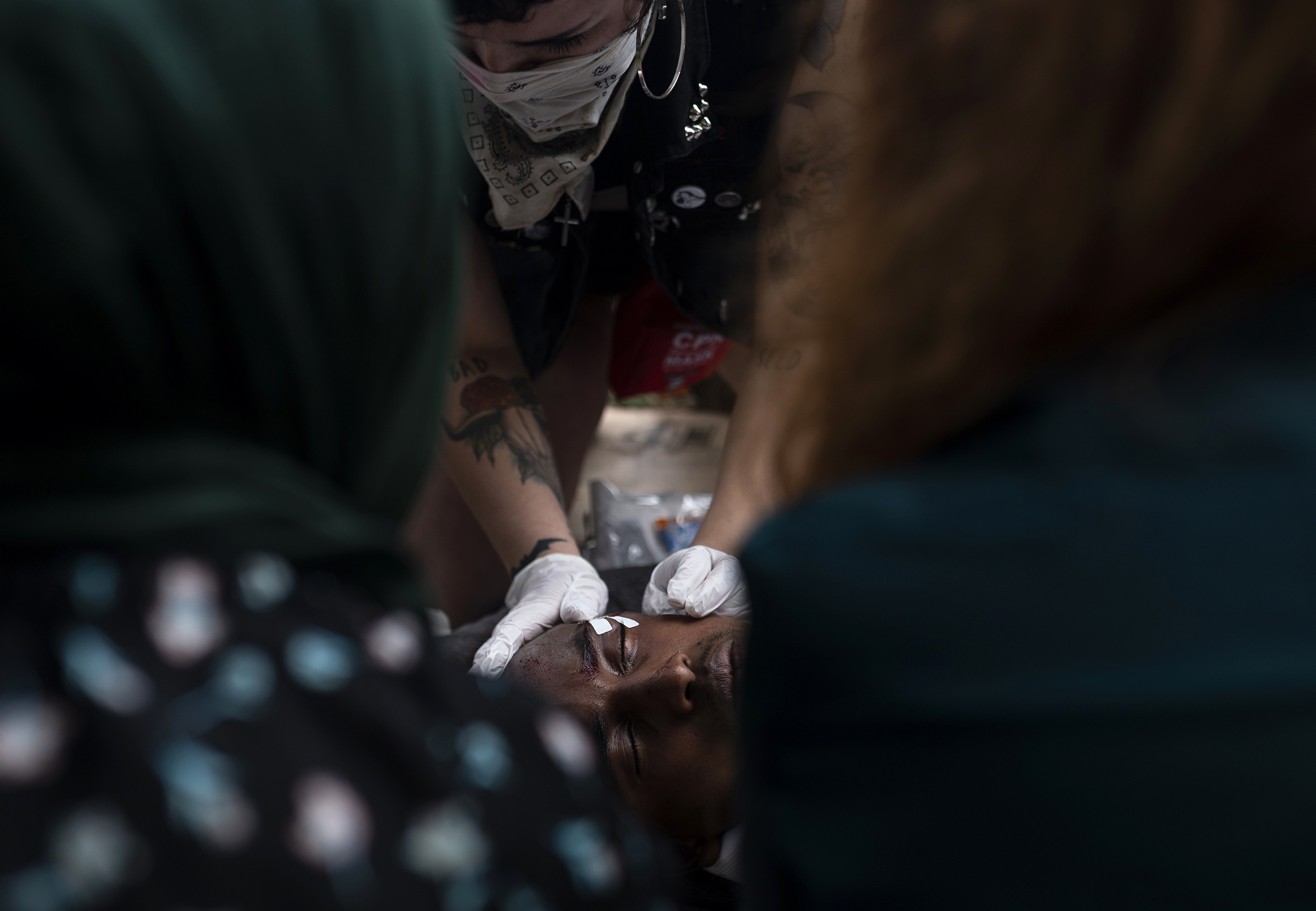 A man is tended to after sustaining an injury from a projectile shot by police outside the 3rd Police Precinct building in Minneapolis, Minn., on May 27, 2020. (Stephen Maturen—Getty Images)