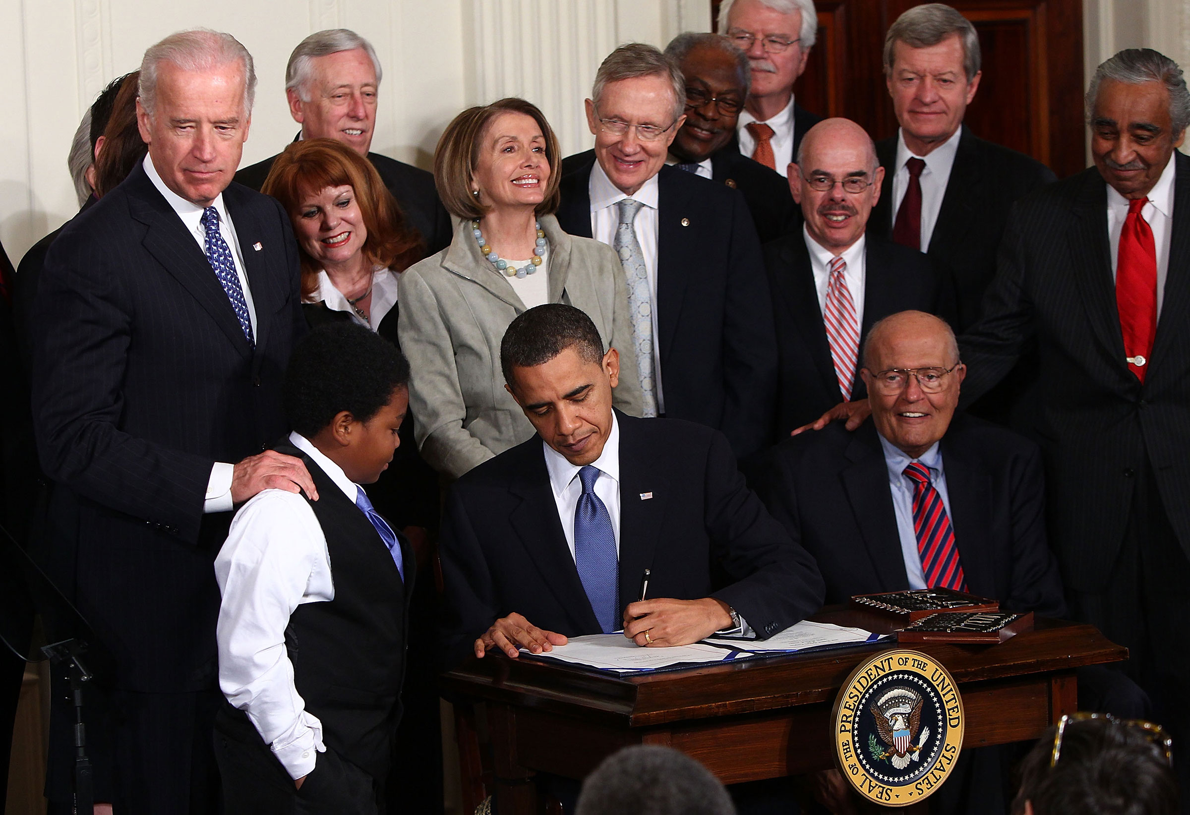 President Barack Obama signs the Affordable Health Care for America Act during a ceremony