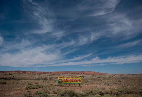 A sign promoting social distancing sits near the Navajo Nation town of Chinle during the 57 hour curfew imposed to try to stop the spread of the Covid-19 virus through the Navajo Nation, in Arizona on May 23, 2020.