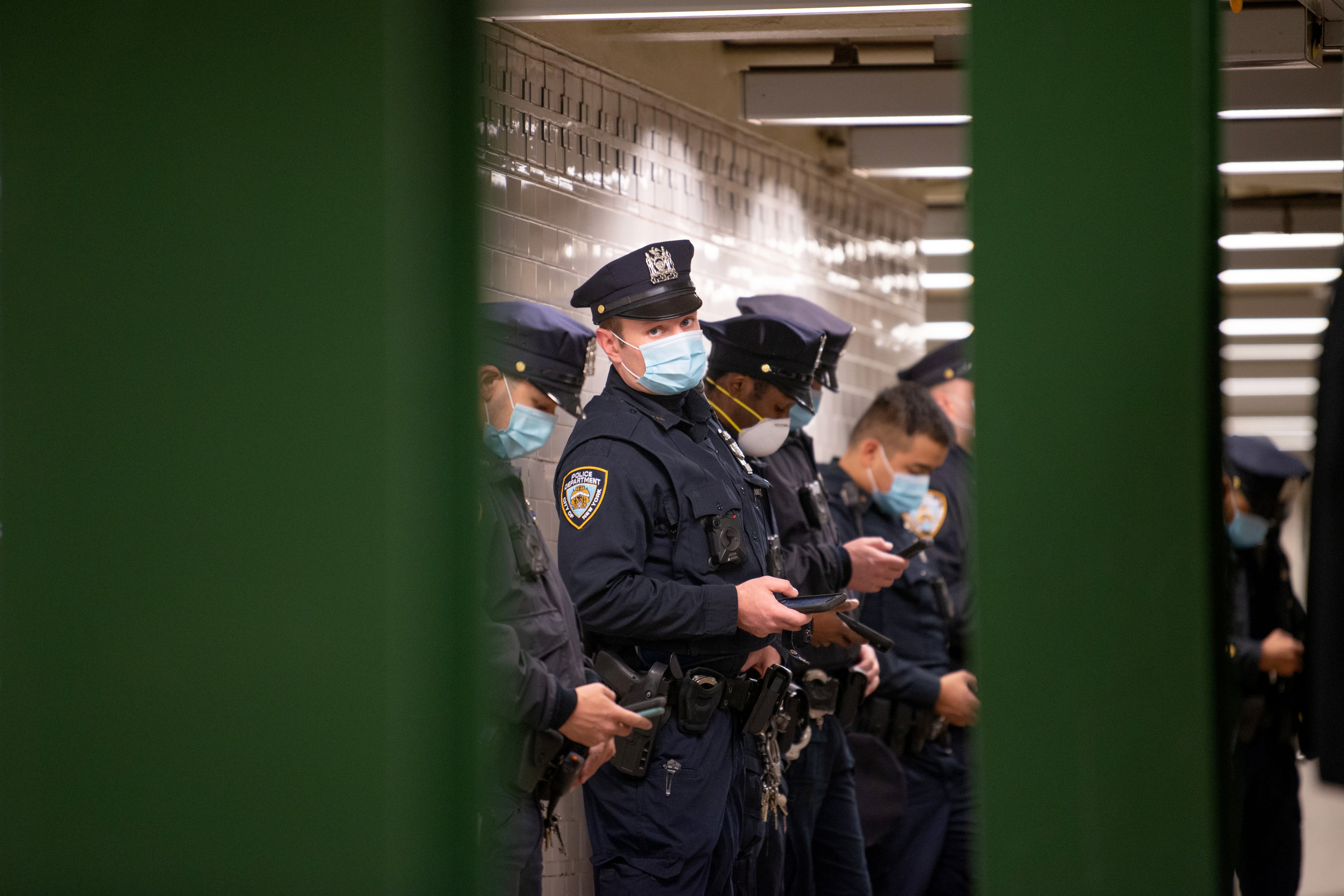 An NYPD officer wearing a mask looks at the camera during a briefing in the Union Square subway station May 6, 2020 in New York City. (Alexi Rosenfeld—Getty Images)