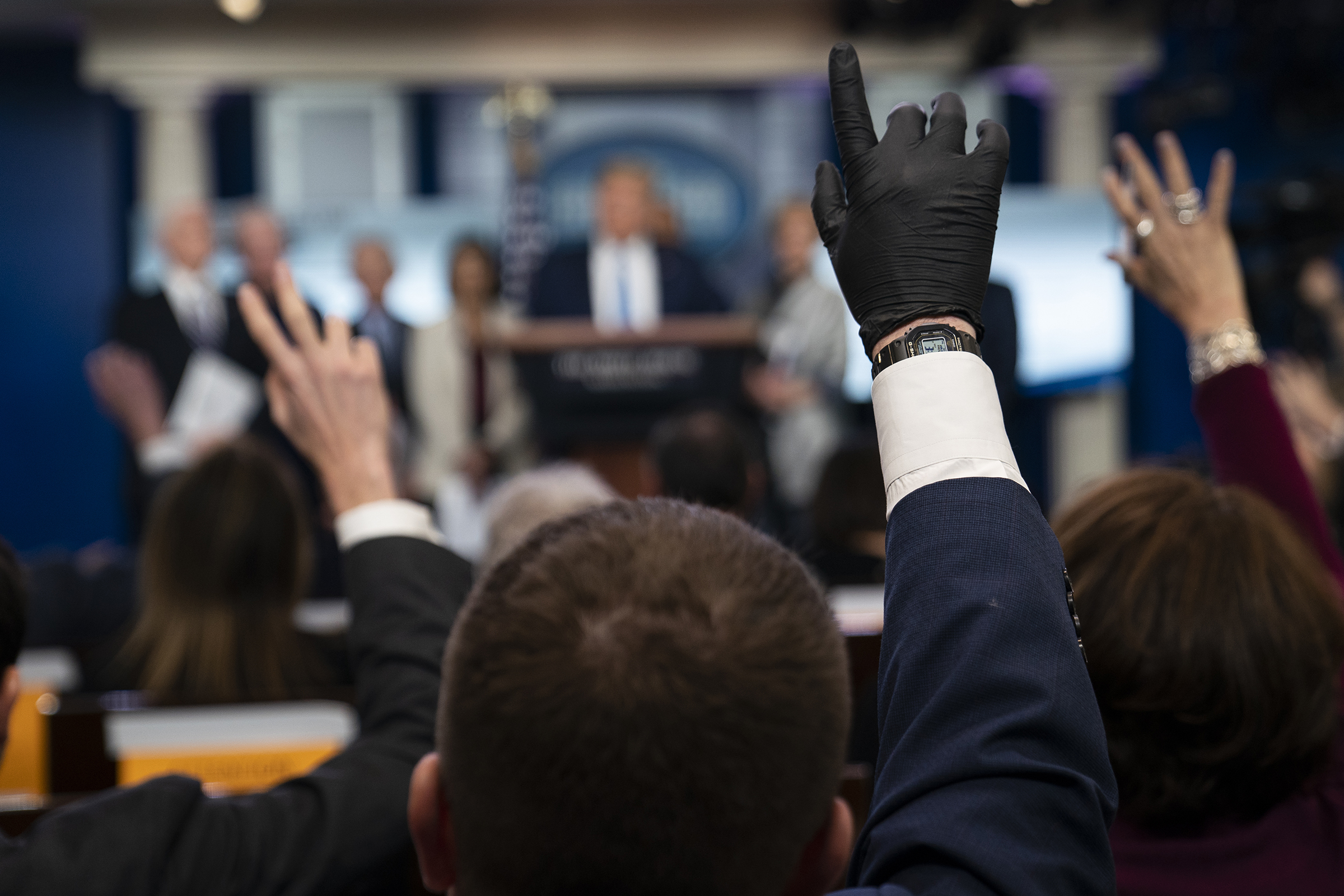 Reporters raise their hands to ask President Donald Trump questions during a press briefing with the coronavirus task force, at the White House on March 16, 2020, in Washington. (Evan Vucci—AP)