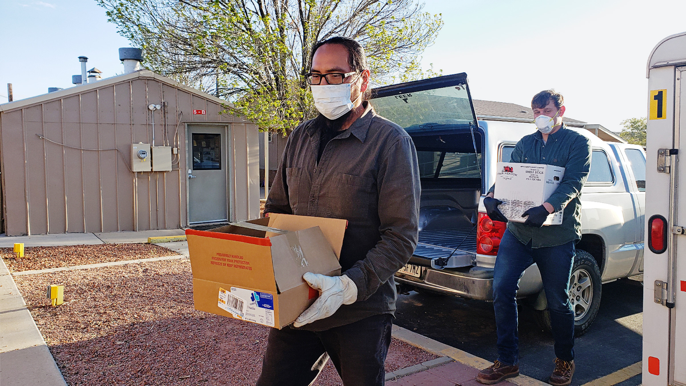 Pete Sands carries boxes of food and cleaning supplies to Navajo Nation members in need. (Sahar Khadjenoury— Utah Navajo COVID-19 Relief Program)