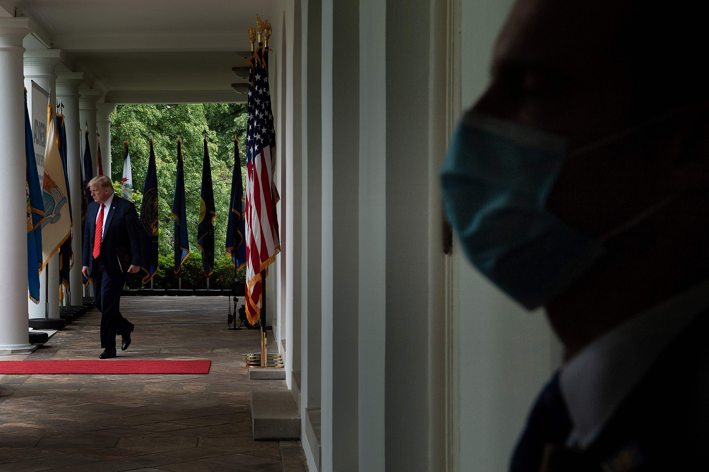 President Trump arrives at a news conference in the Rose Garden on May 11 wearing no mask, despite CDC guidelines advising Americans to use them (Brendan Smialowski—AFP/Getty Images)